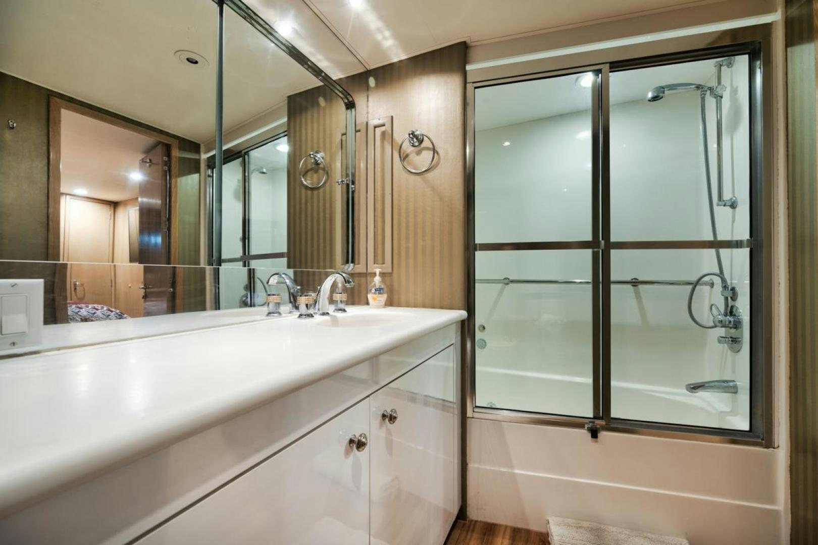a bathroom with a large mirror aboard HATT'S OFF Yacht for Sale