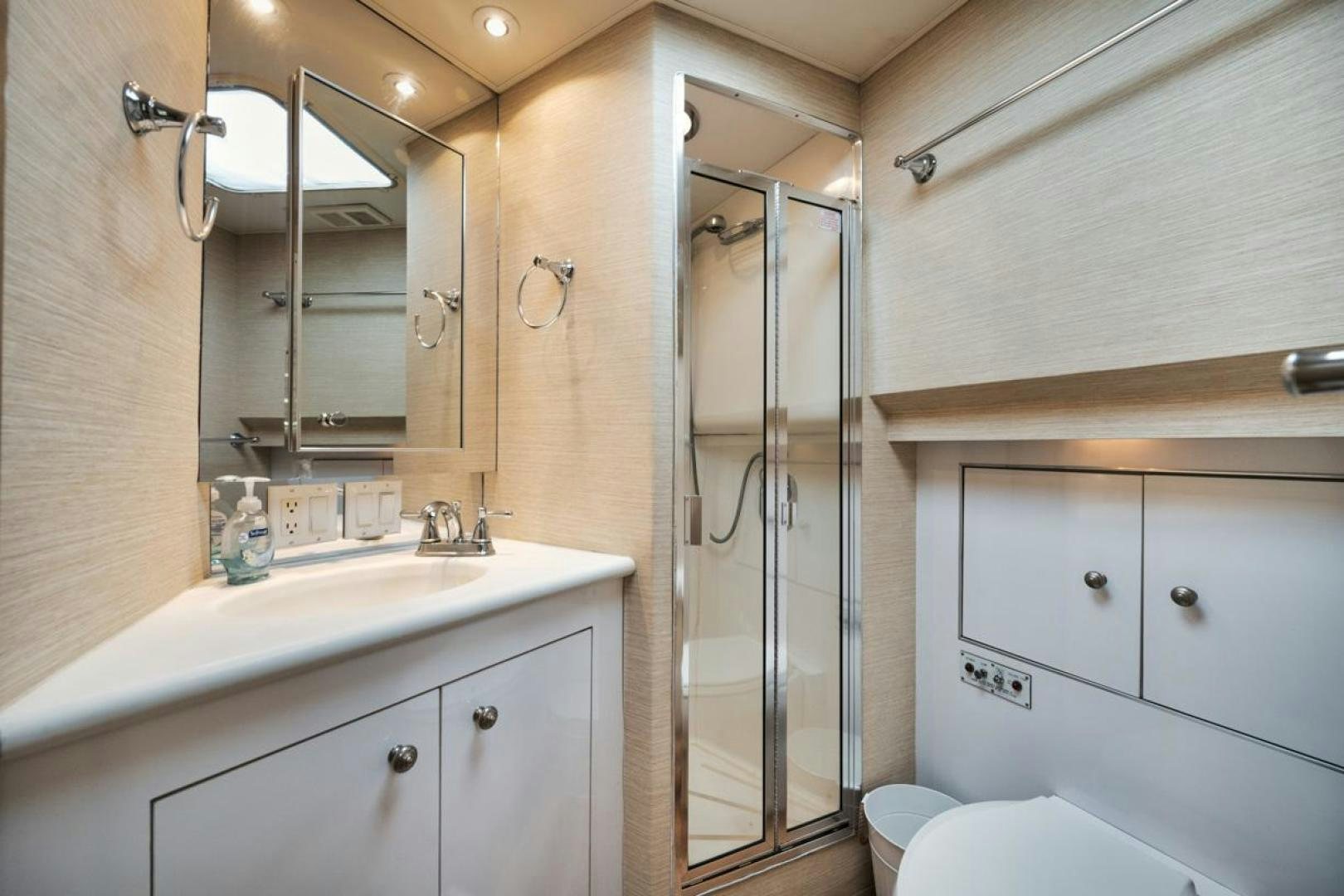 a bathroom with a glass shower aboard HATT'S OFF Yacht for Sale