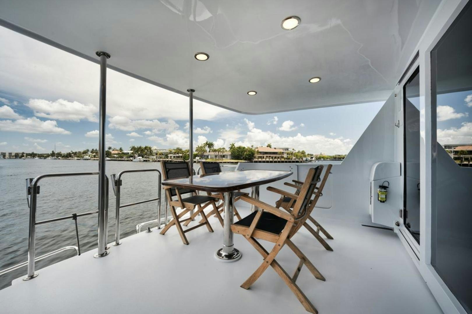 a table and chairs on a deck aboard HATT'S OFF Yacht for Sale