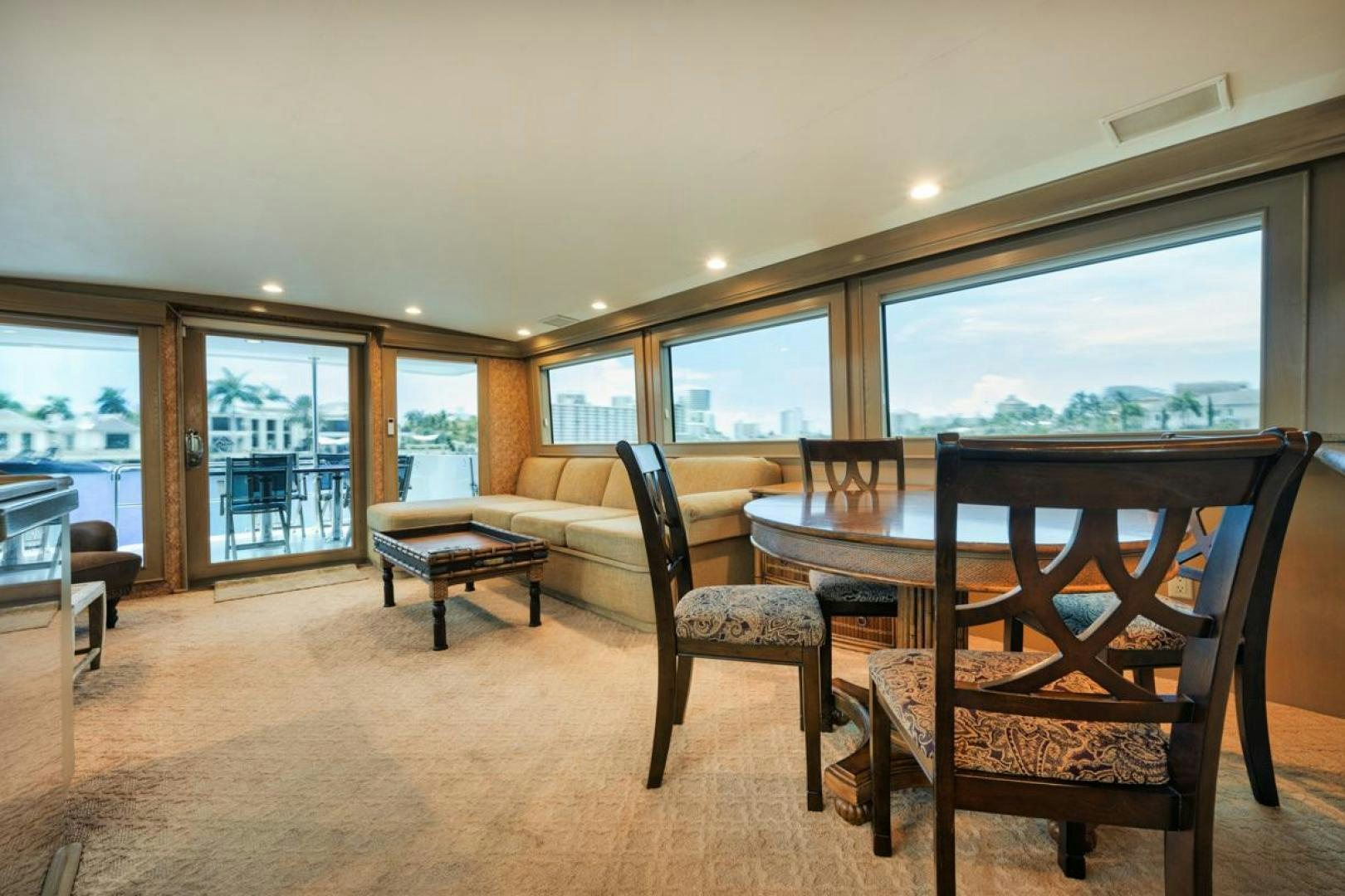 a living room with a table and chairs aboard HATT'S OFF Yacht for Sale