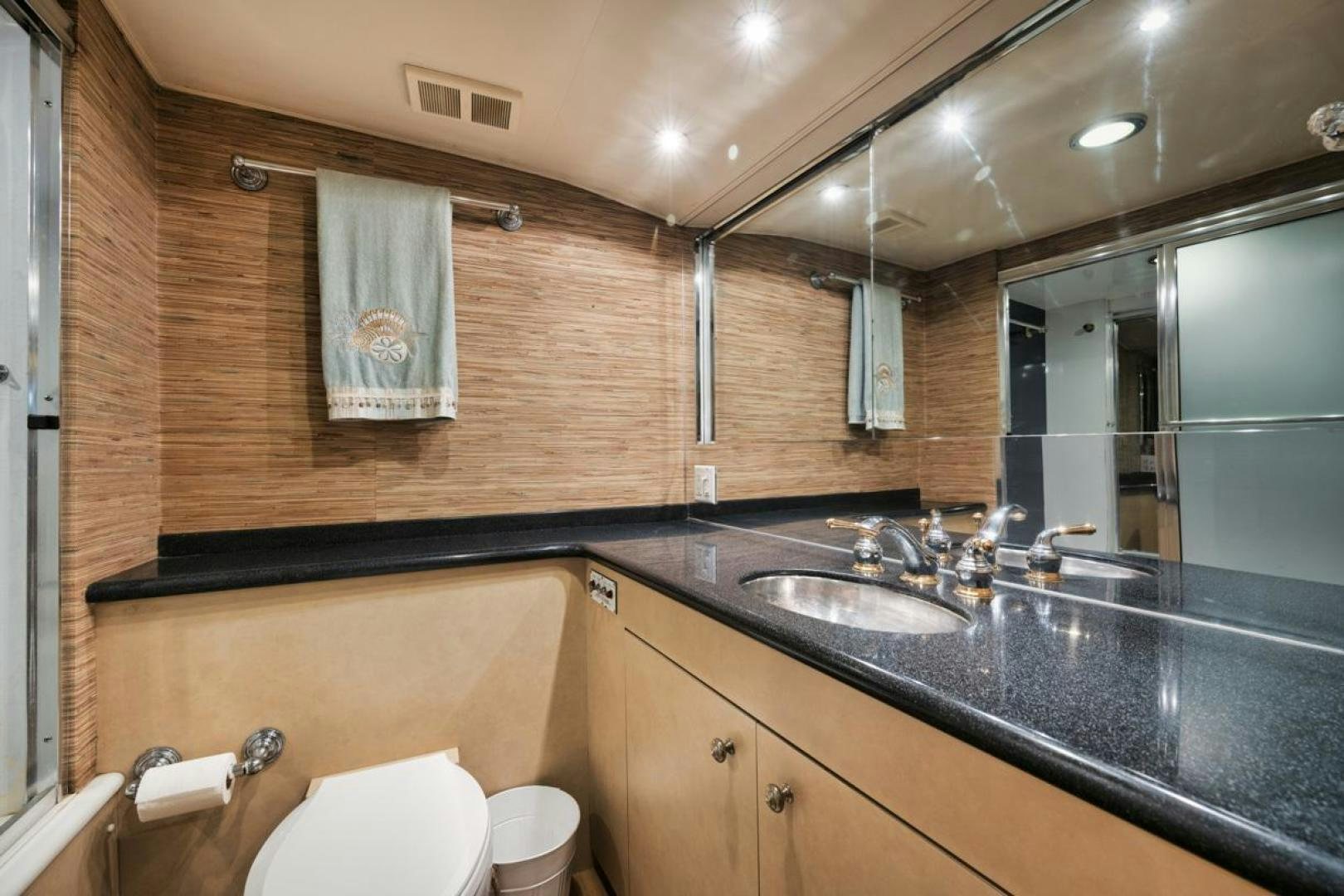 a bathroom with a sink and a mirror aboard HATT'S OFF Yacht for Sale