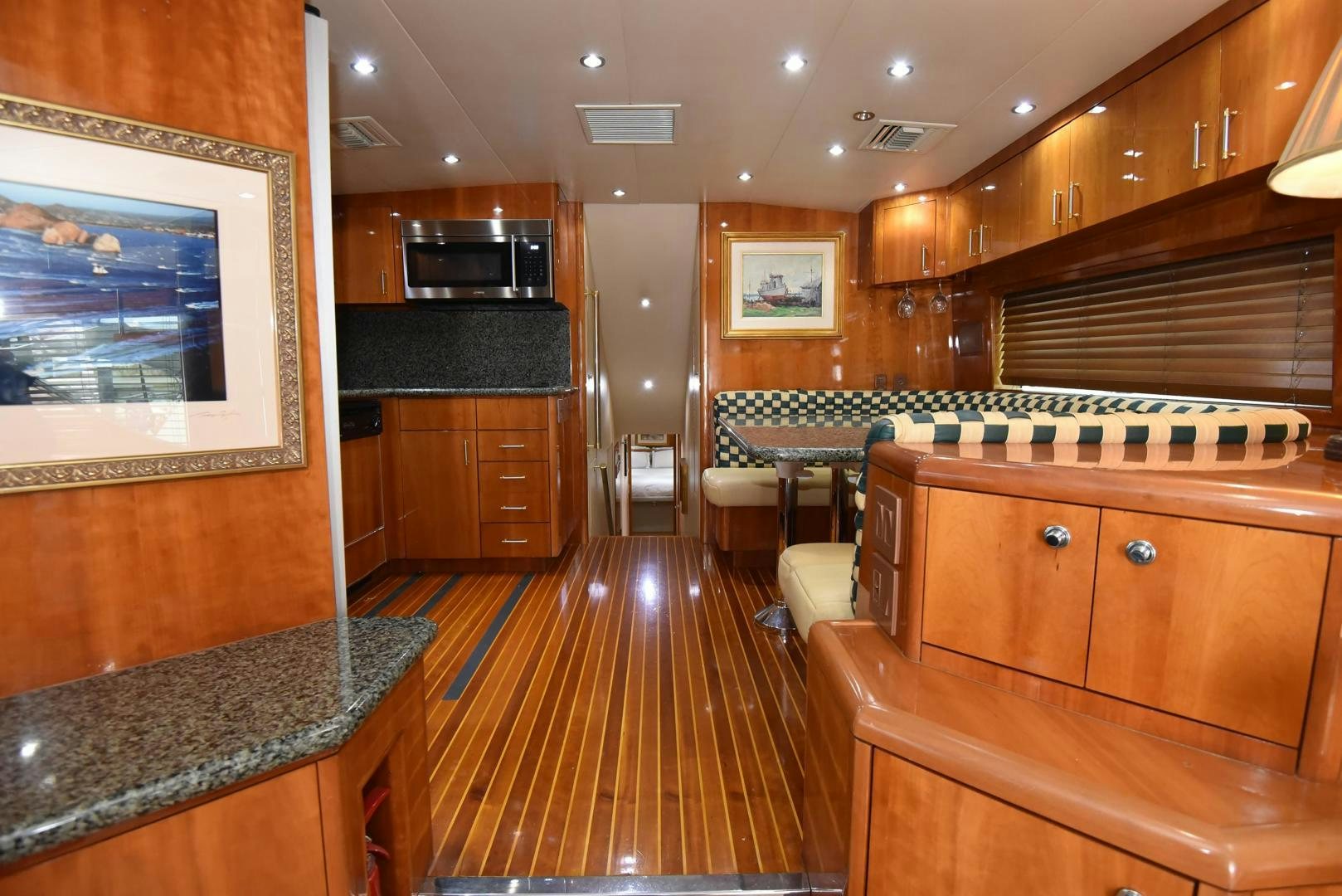a kitchen with wooden cabinets aboard SALSA Yacht for Sale