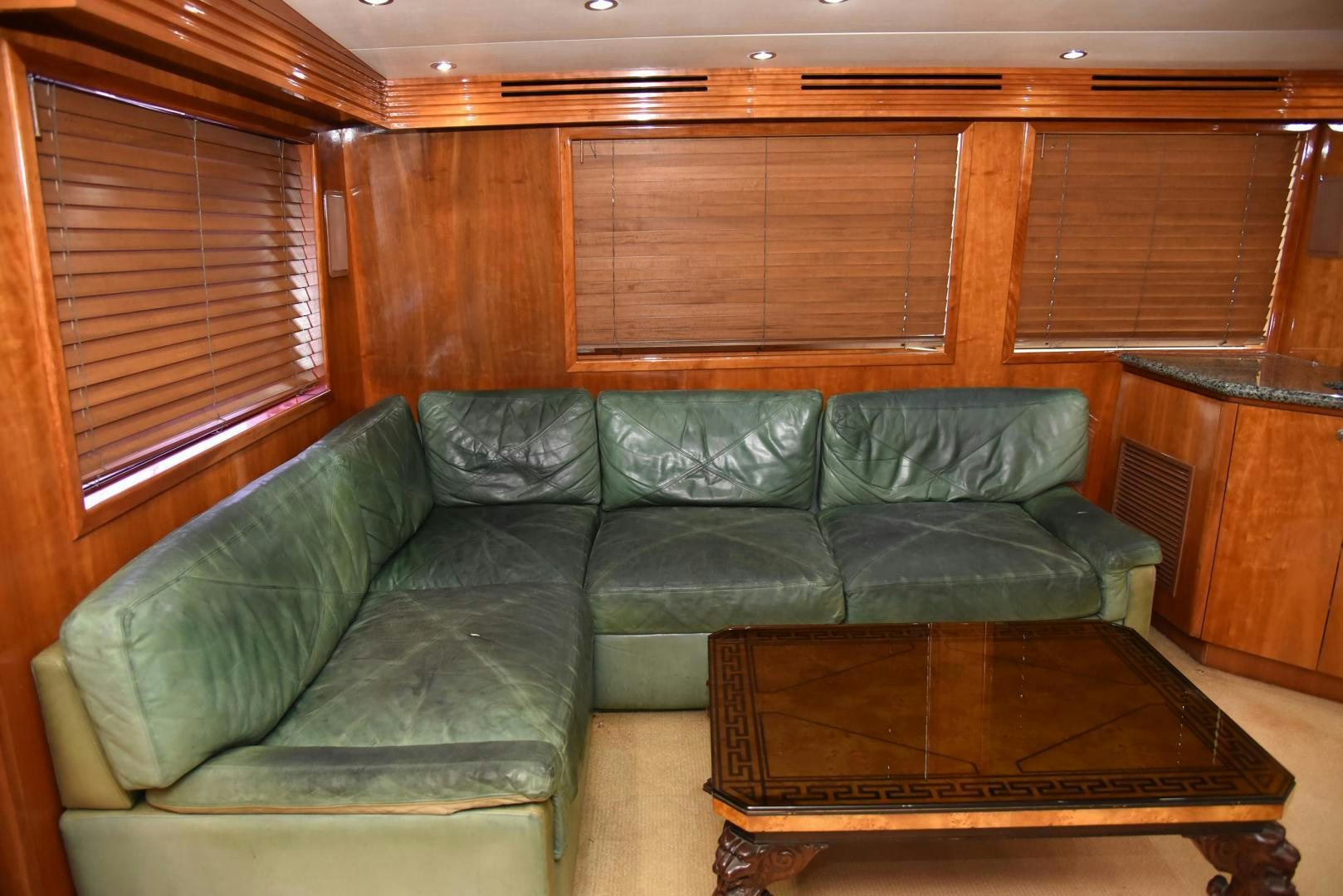 a green couch in a room aboard SALSA Yacht for Sale