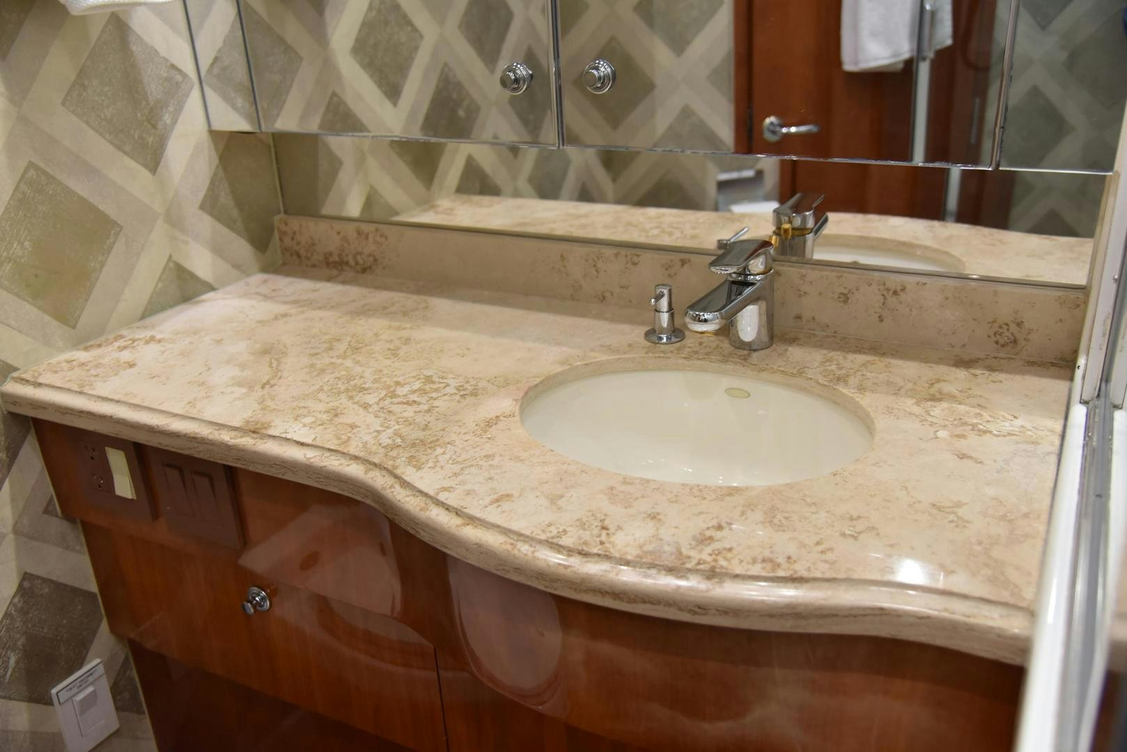 a bathroom with a sink and a mirror aboard SALSA Yacht for Sale