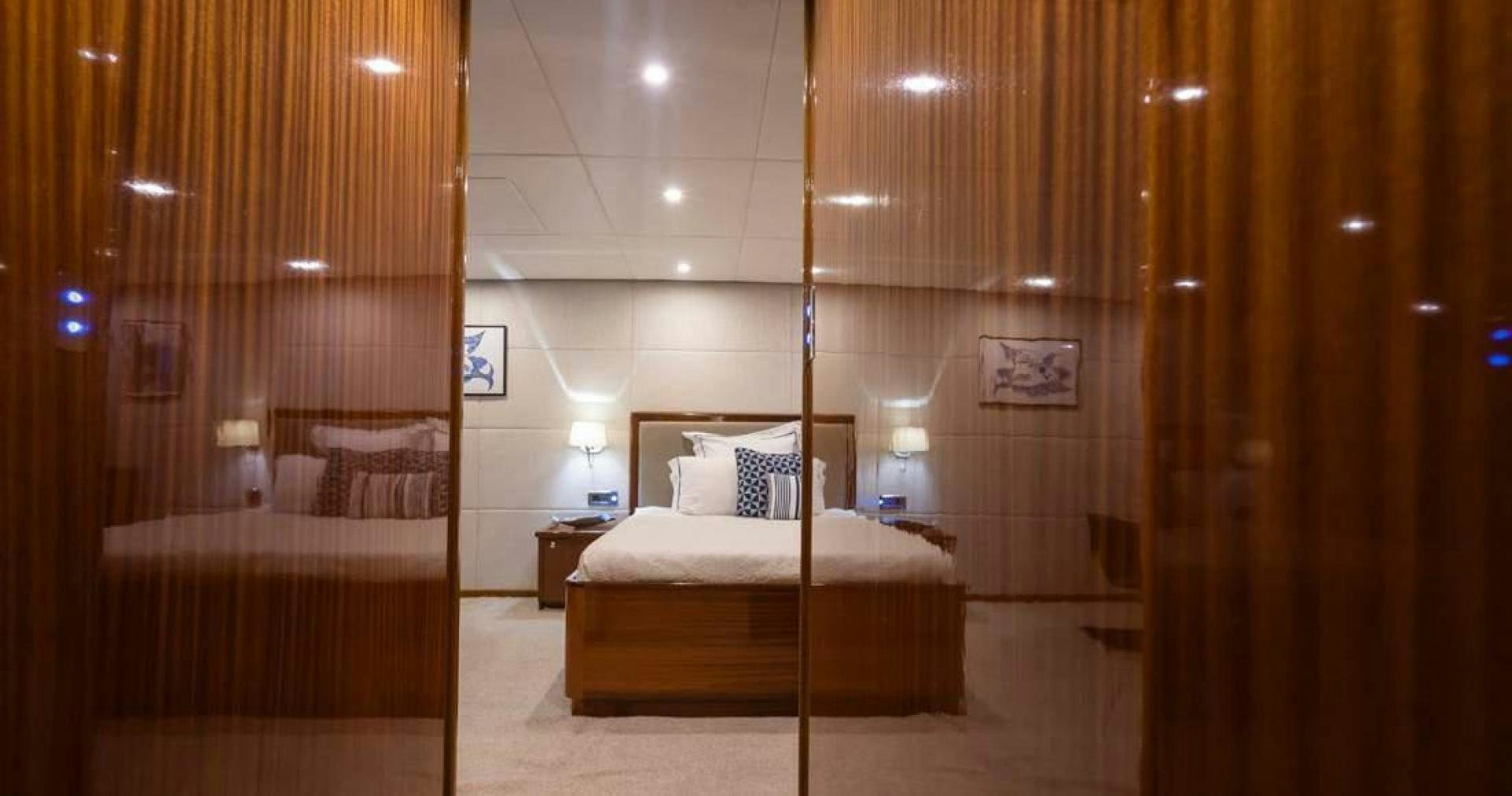 a room with a bed and a mirror aboard ALHAMBRA Yacht for Sale