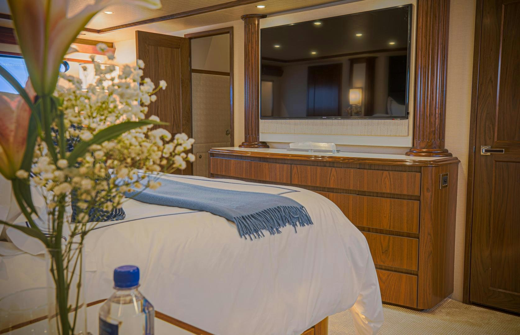 a bed with a blue blanket aboard SPECULATOR Yacht for Sale