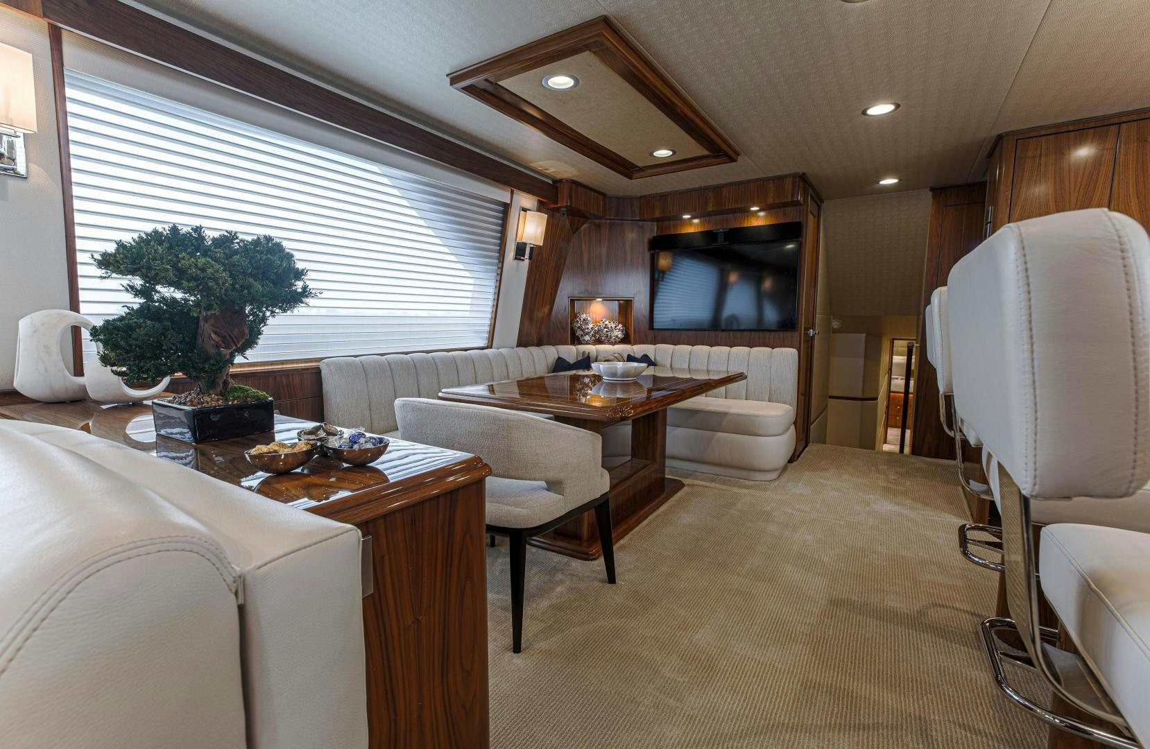 a large living room with a table and chairs aboard SPECULATOR Yacht for Sale