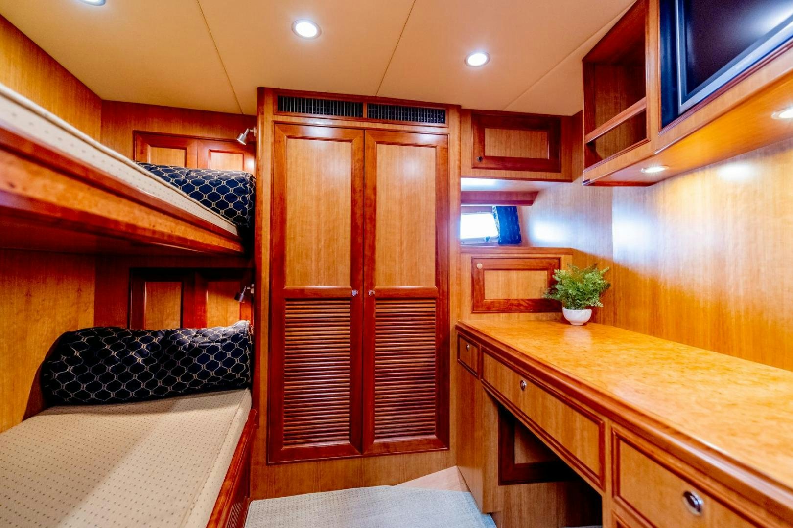 a room with wooden cabinets aboard HONORE Yacht for Sale