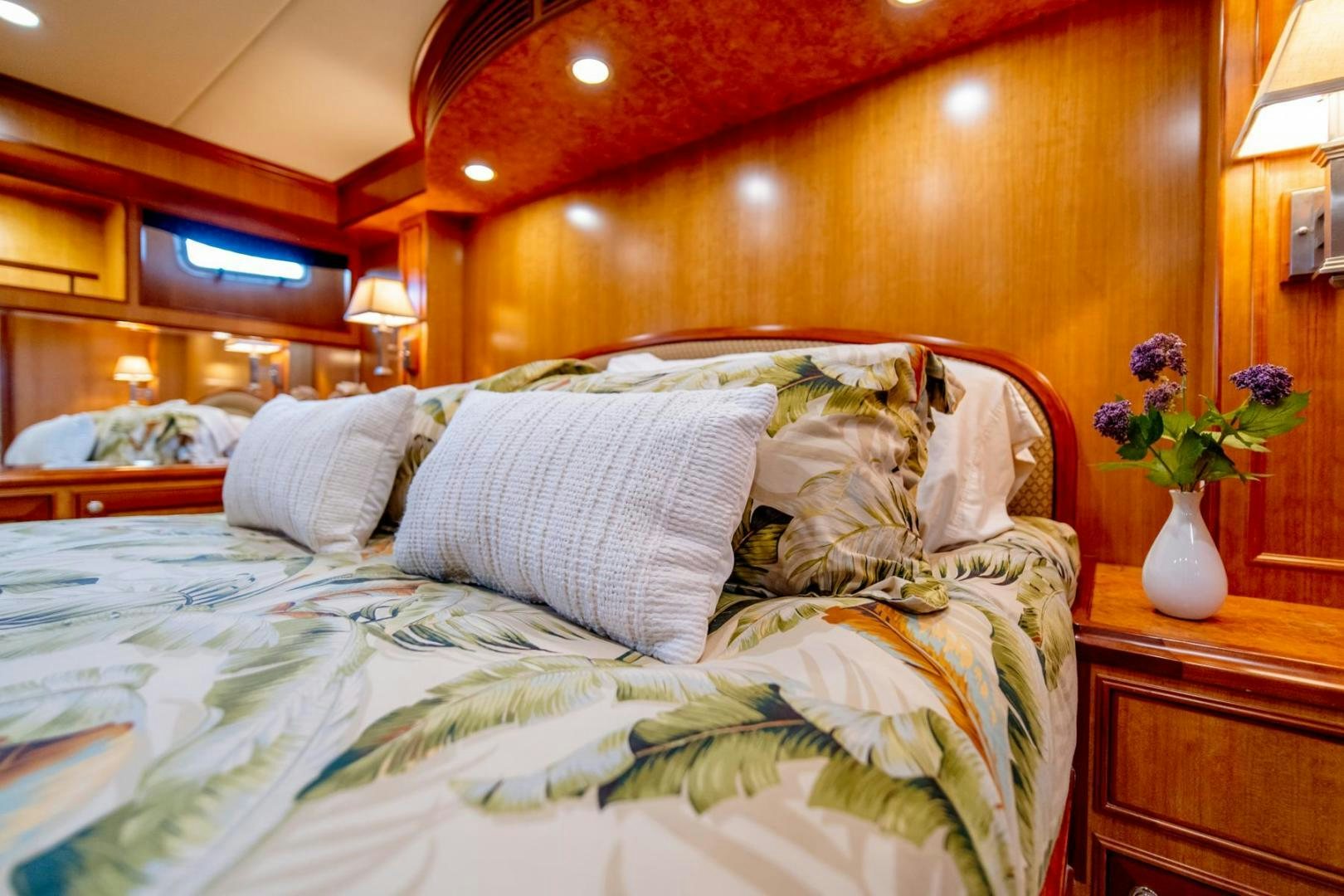 a bed with white sheets aboard HONORE Yacht for Sale