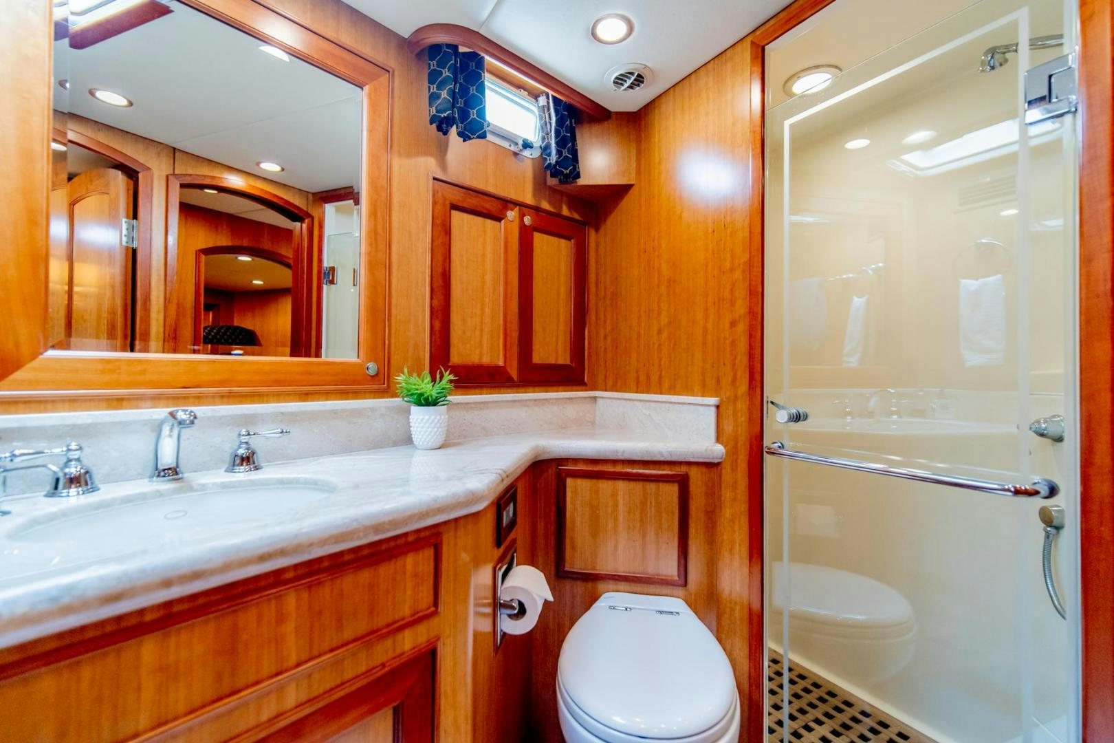 a bathroom with a glass shower aboard HONORE Yacht for Sale