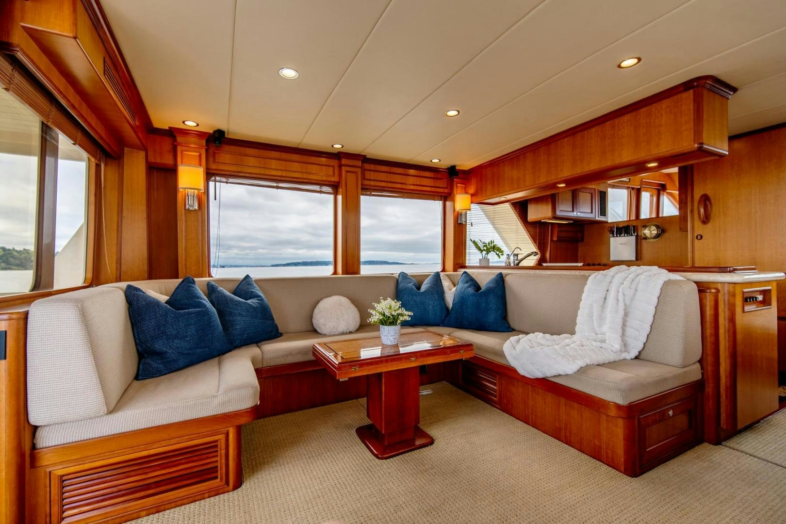 a living room with a couch and a table aboard HONORE Yacht for Sale