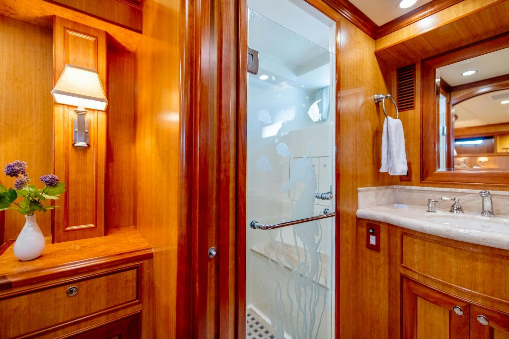 a bathroom with a glass shower aboard HONORE Yacht for Sale