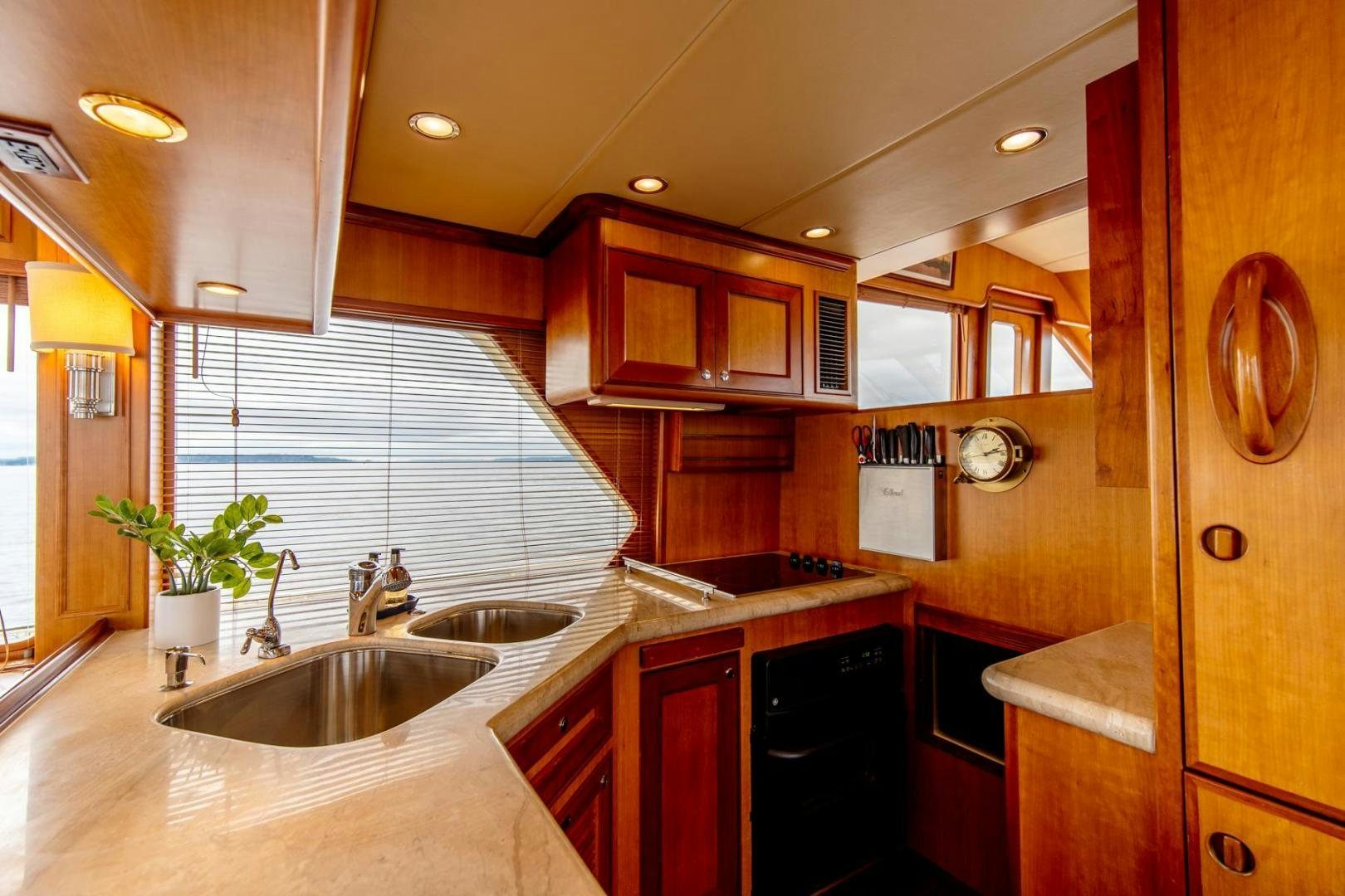 a kitchen with wooden cabinets aboard HONORE Yacht for Sale