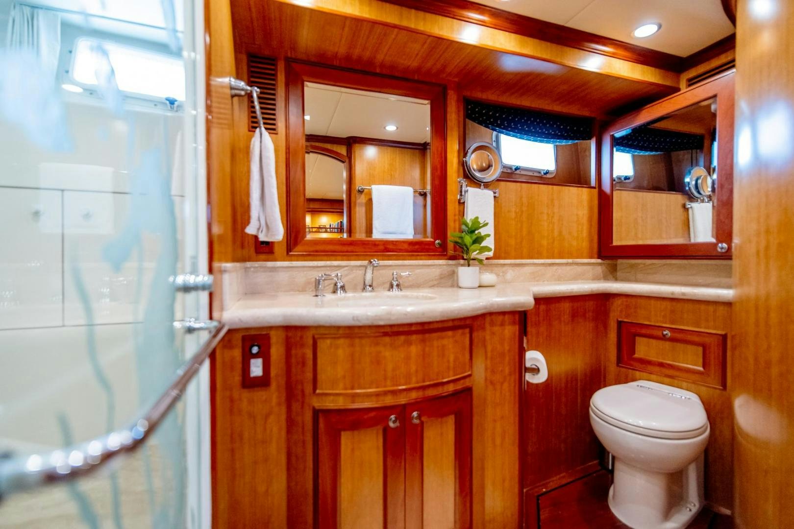 a bathroom with a toilet and a sink aboard HONORE Yacht for Sale