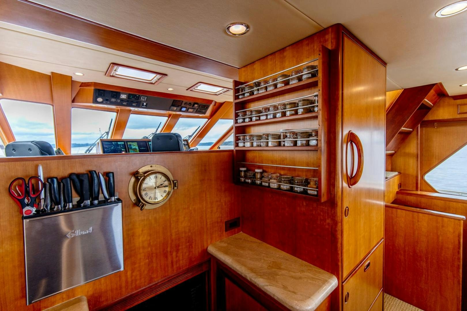 a kitchen with a large clock aboard HONORE Yacht for Sale