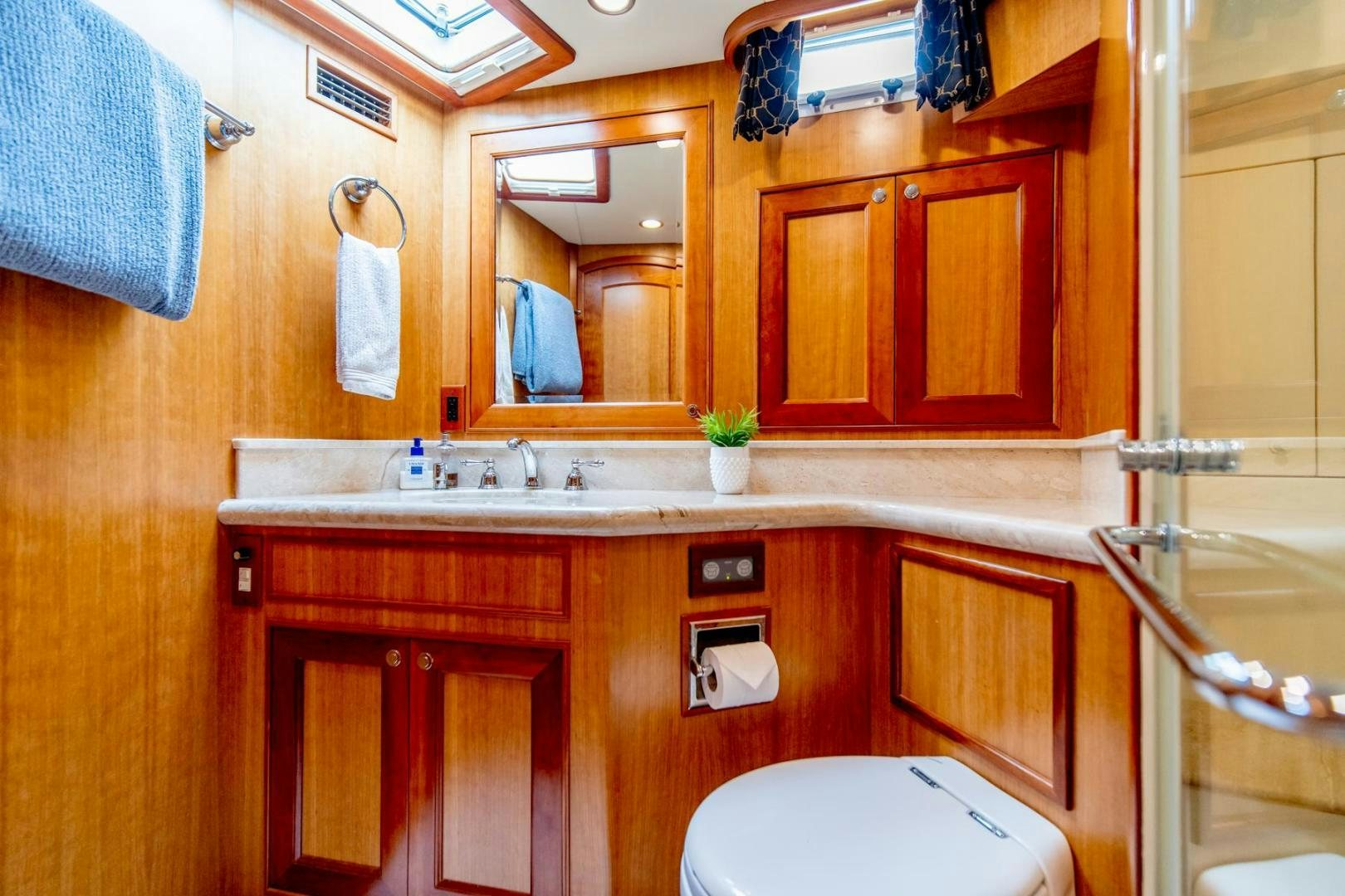 a bathroom with wooden cabinets aboard HONORE Yacht for Sale