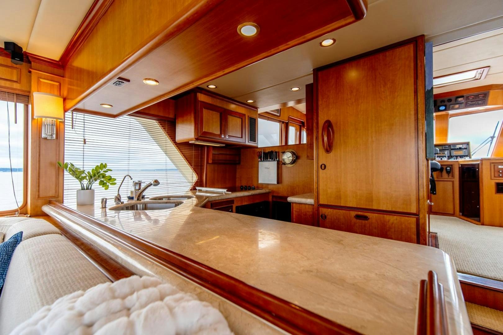 a large kitchen with wooden cabinets aboard HONORE Yacht for Sale