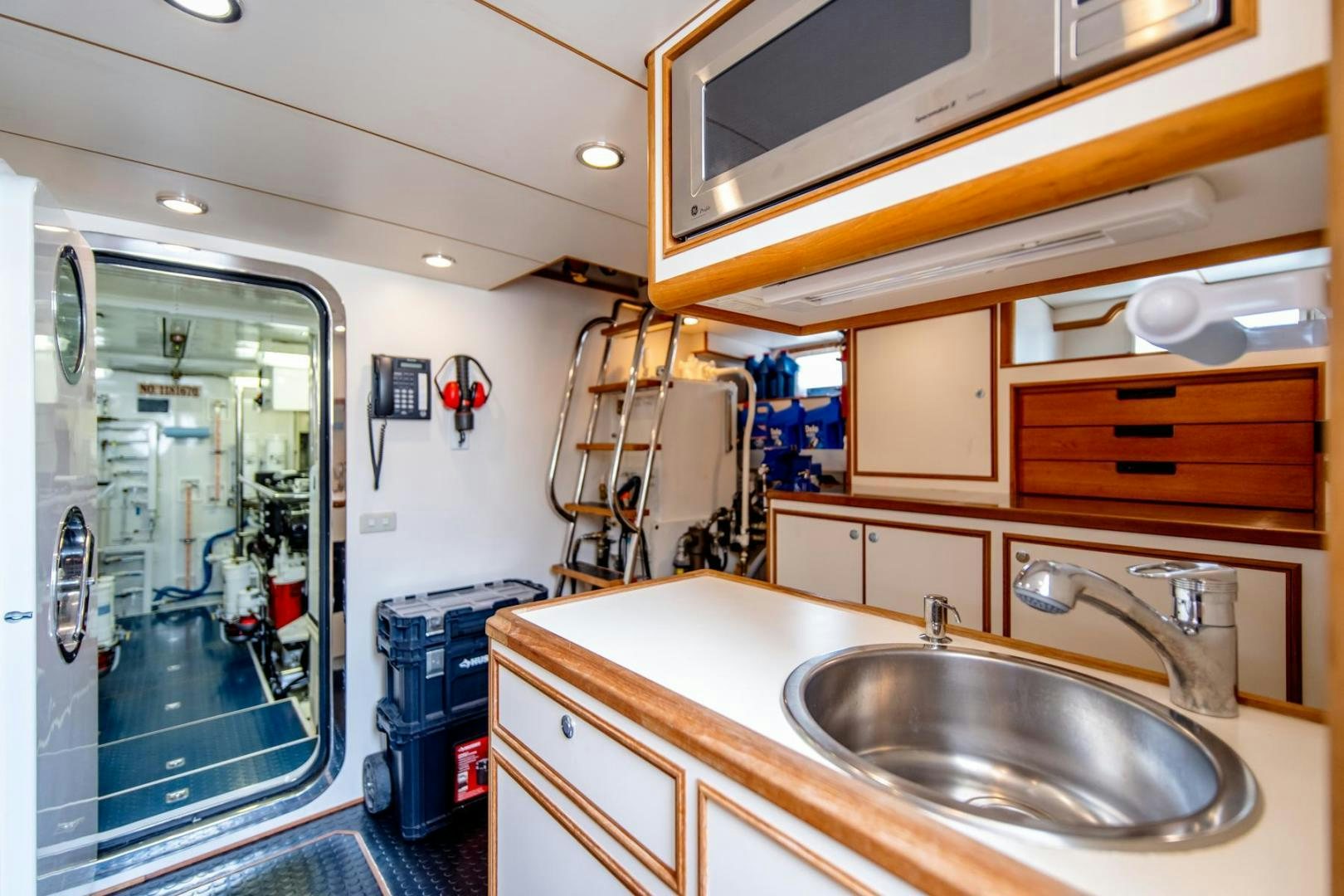 a kitchen with a sink and a mirror aboard HONORE Yacht for Sale