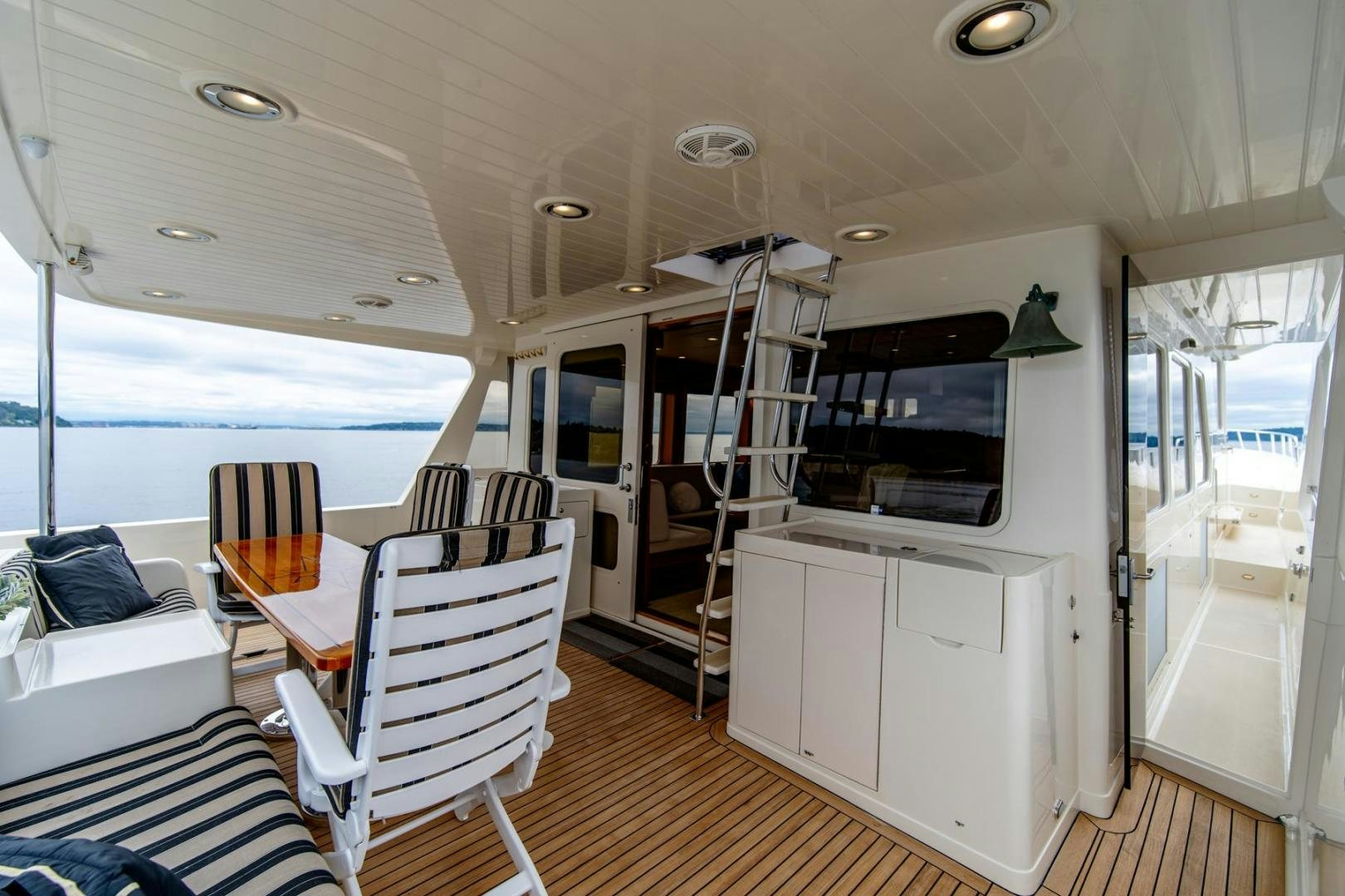 a boat with a ladder and chairs aboard HONORE Yacht for Sale