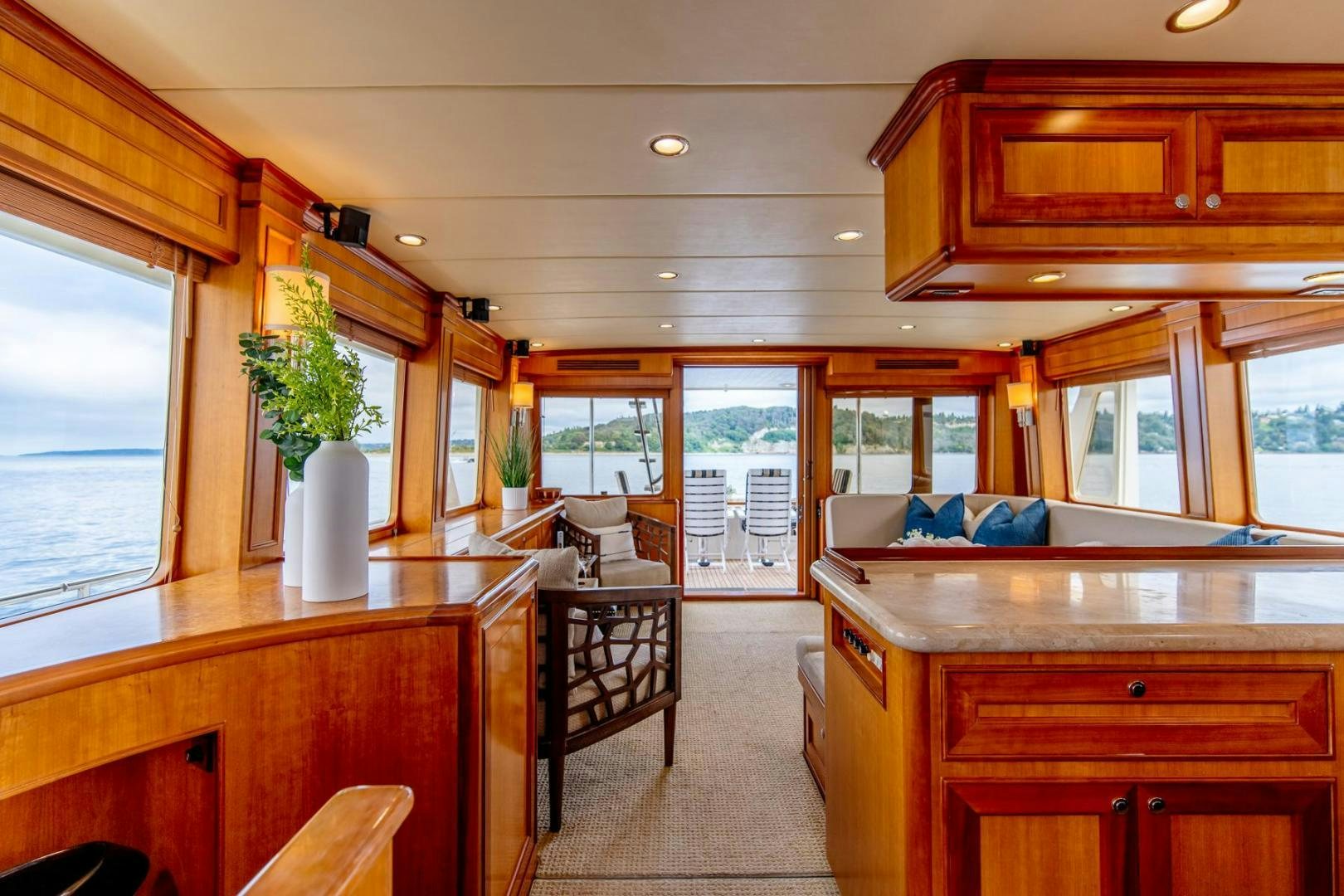 a large kitchen with wooden cabinets aboard HONORE Yacht for Sale