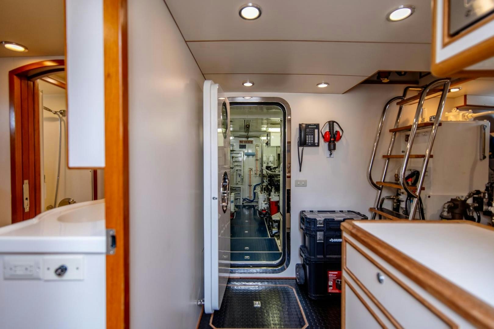 a room with a door and a ladder aboard HONORE Yacht for Sale