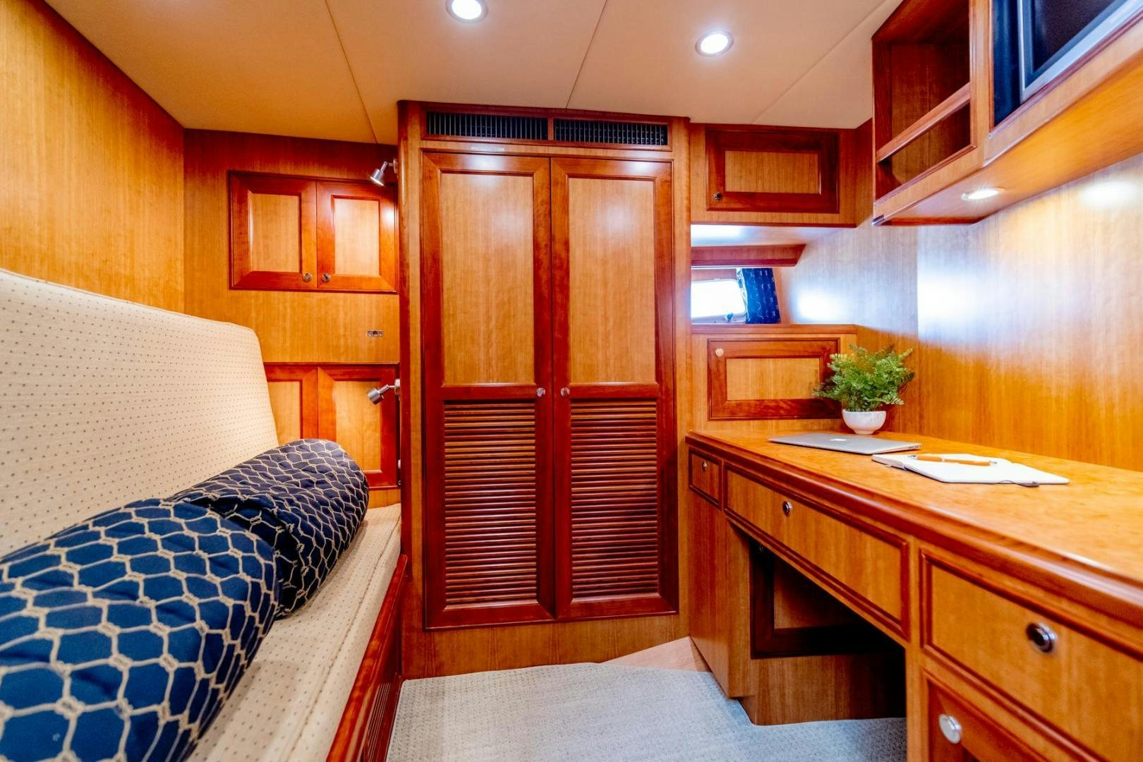 a room with wooden cabinets aboard HONORE Yacht for Sale