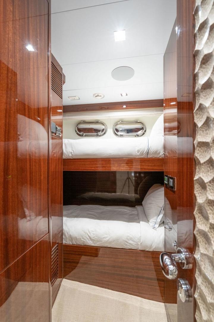 a room with a bed and a wood door aboard AQUA LIFE Yacht for Sale
