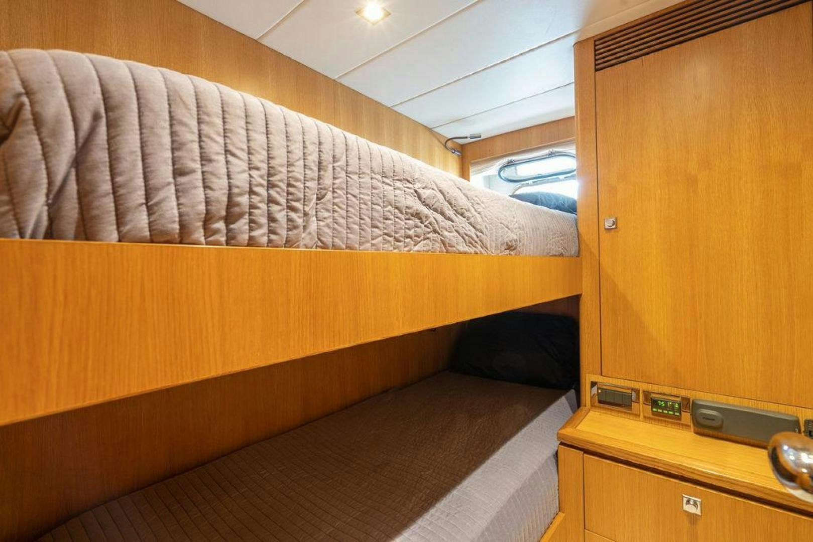 a bed with a wooden frame aboard AQUA LIFE Yacht for Sale