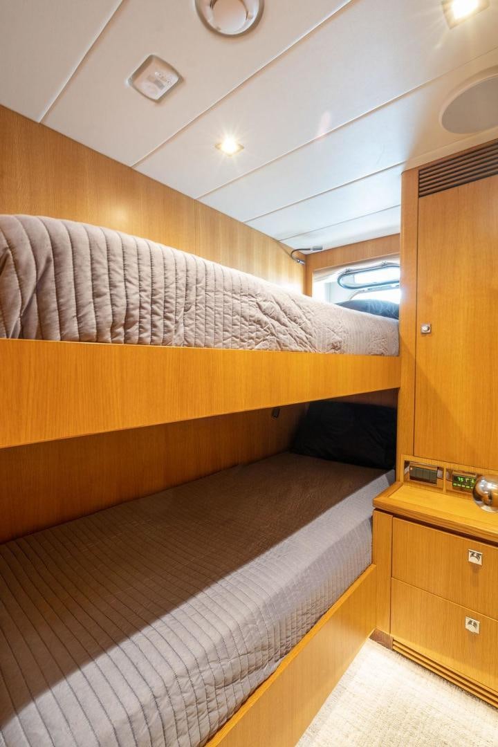 a bed with a wooden headboard aboard AQUA LIFE Yacht for Sale