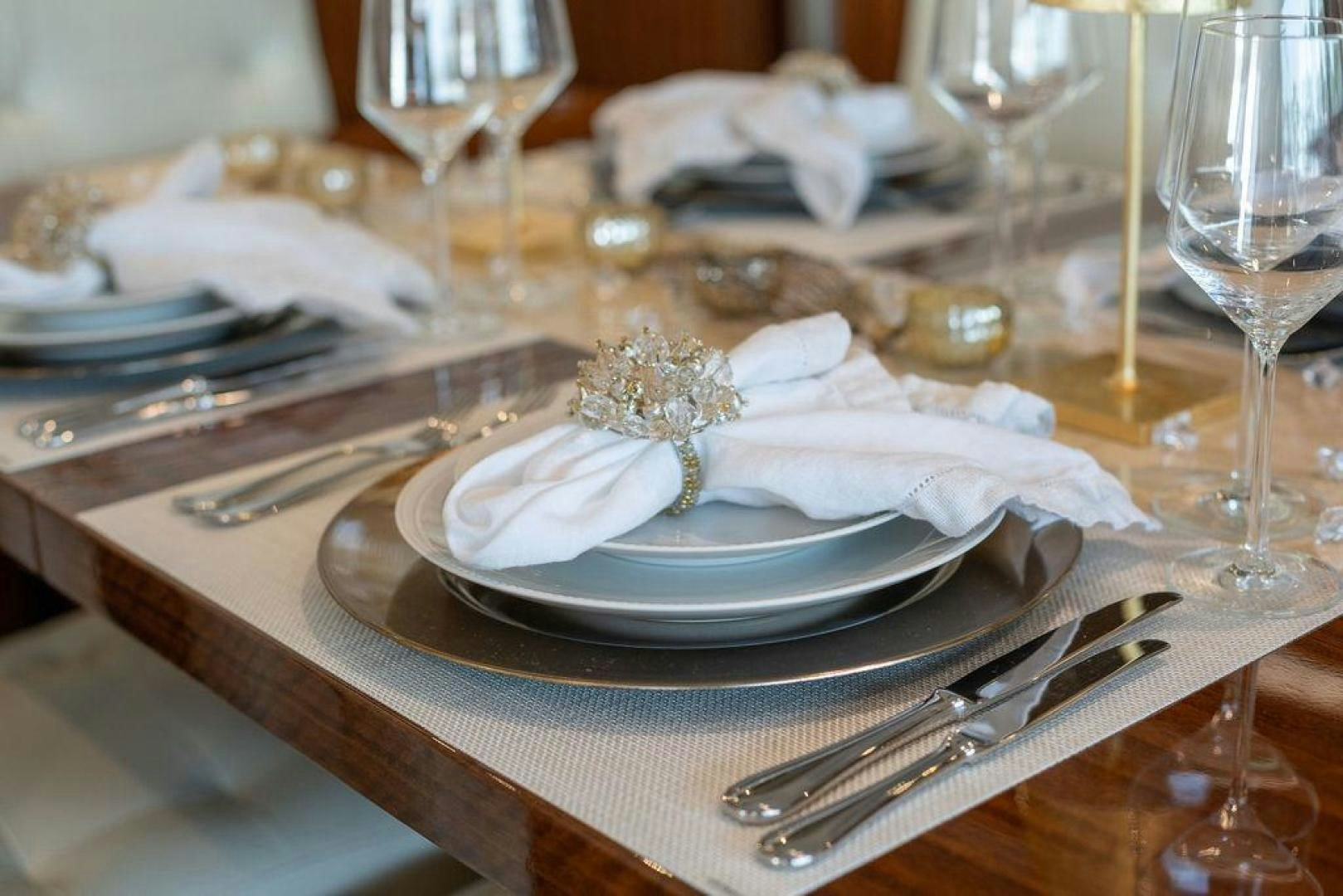 a table with plates and glasses aboard AQUA LIFE Yacht for Sale