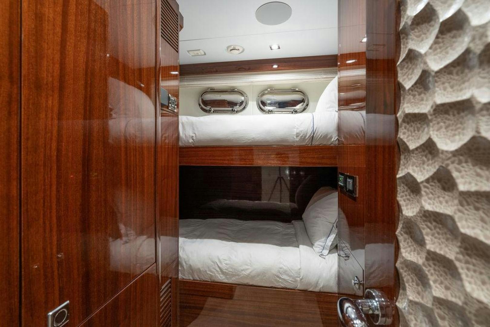 a room with a bed and a wood cabinet aboard AQUA LIFE Yacht for Sale