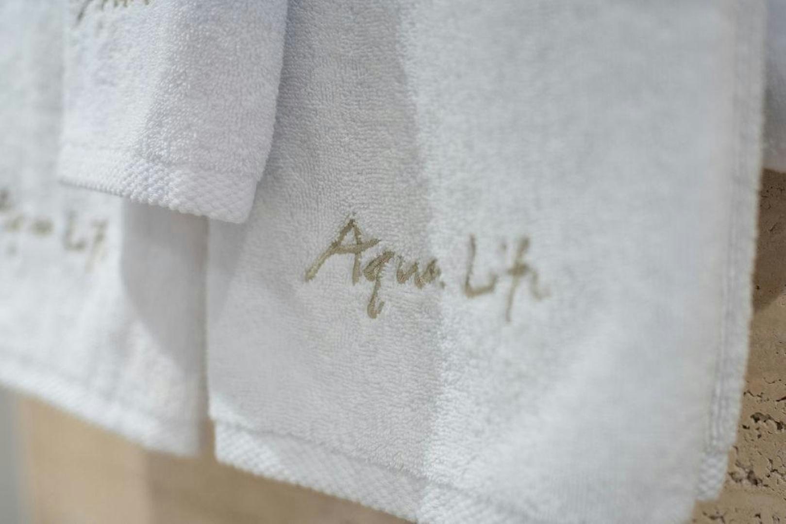 a white shirt with a symbol aboard AQUA LIFE Yacht for Sale