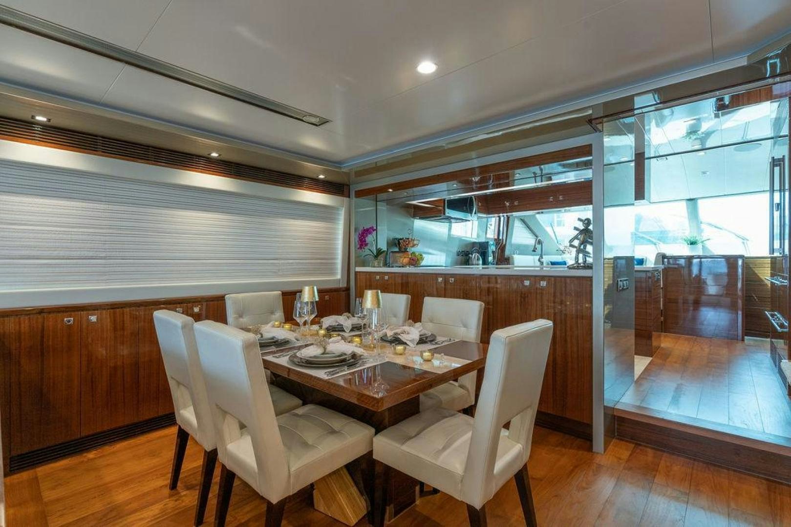 a dining table and chairs in a room with wood floors aboard AQUA LIFE Yacht for Sale