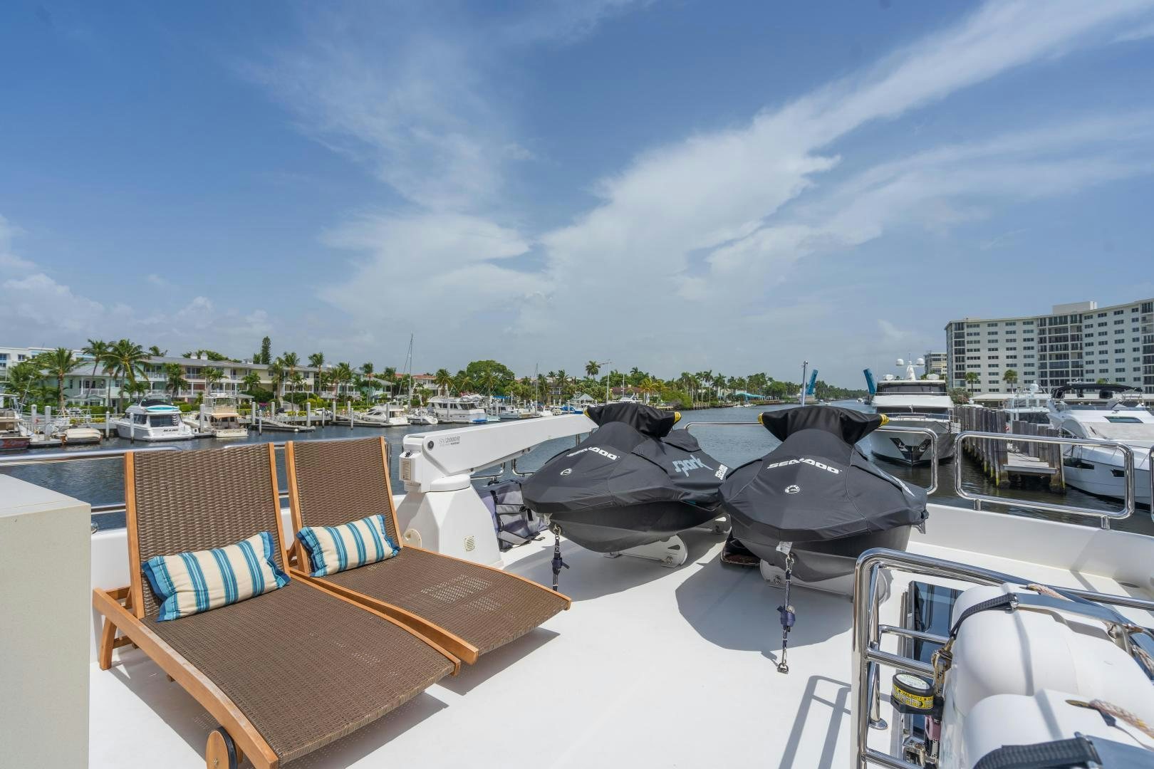 a deck with boats and a city in the background aboard AQUA LIFE Yacht for Sale