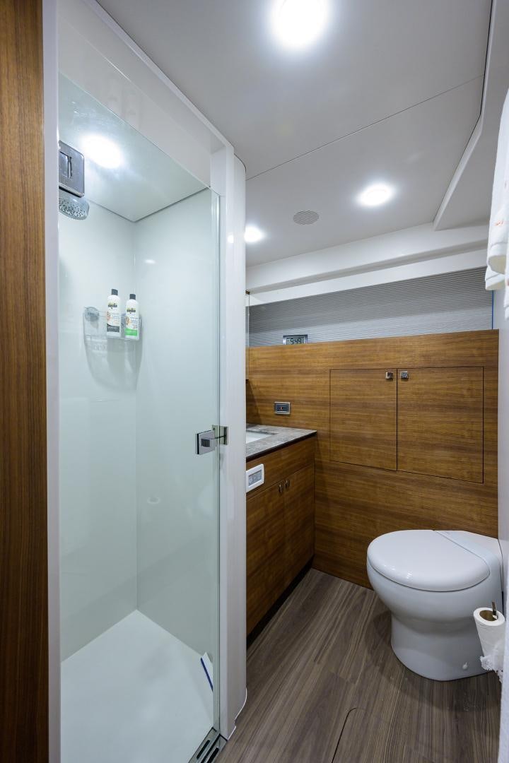 a bathroom with a shower unit and a toilet aboard MY 3 GALS Yacht for Sale