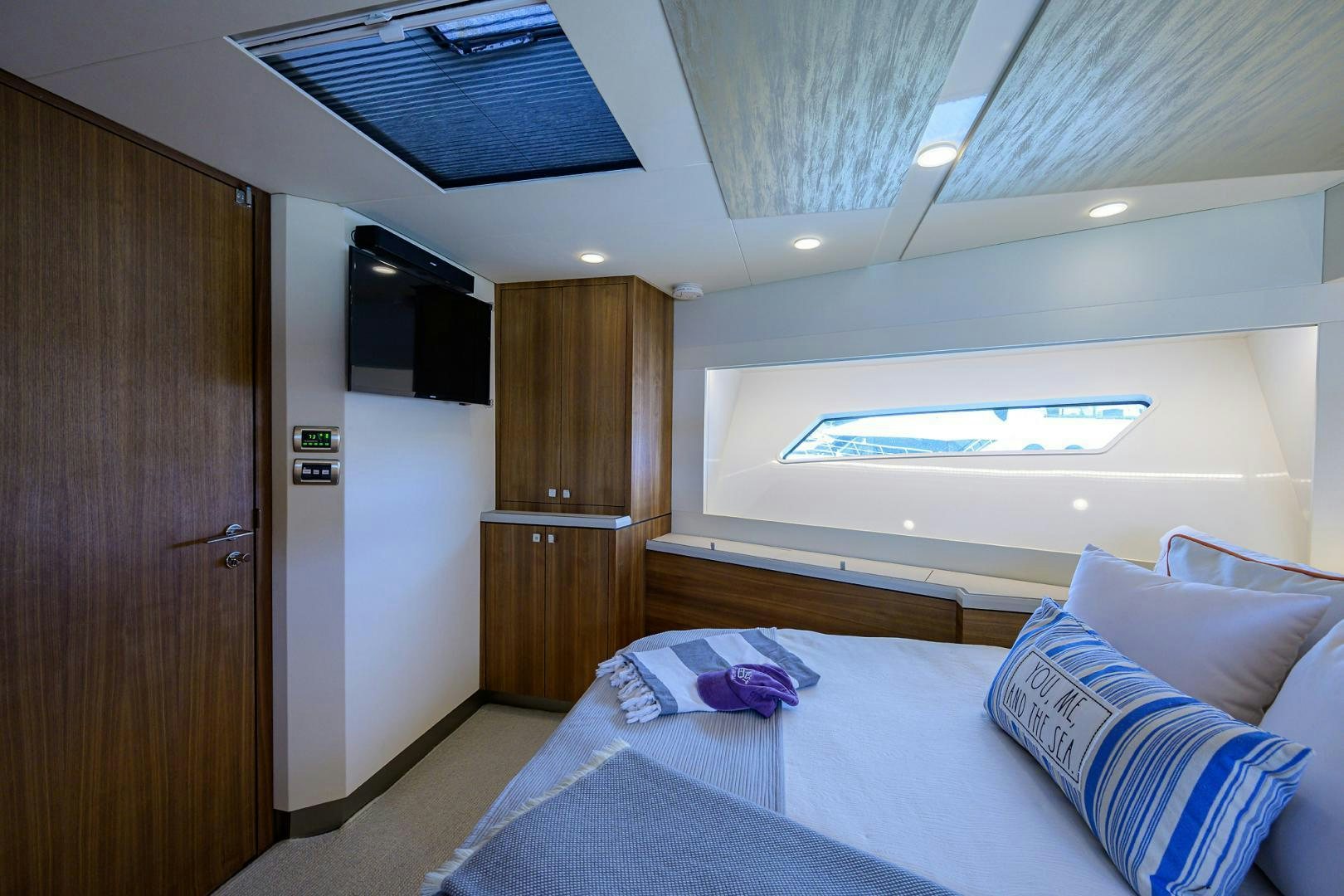 a bedroom with a bed and a wood door aboard MY 3 GALS Yacht for Sale