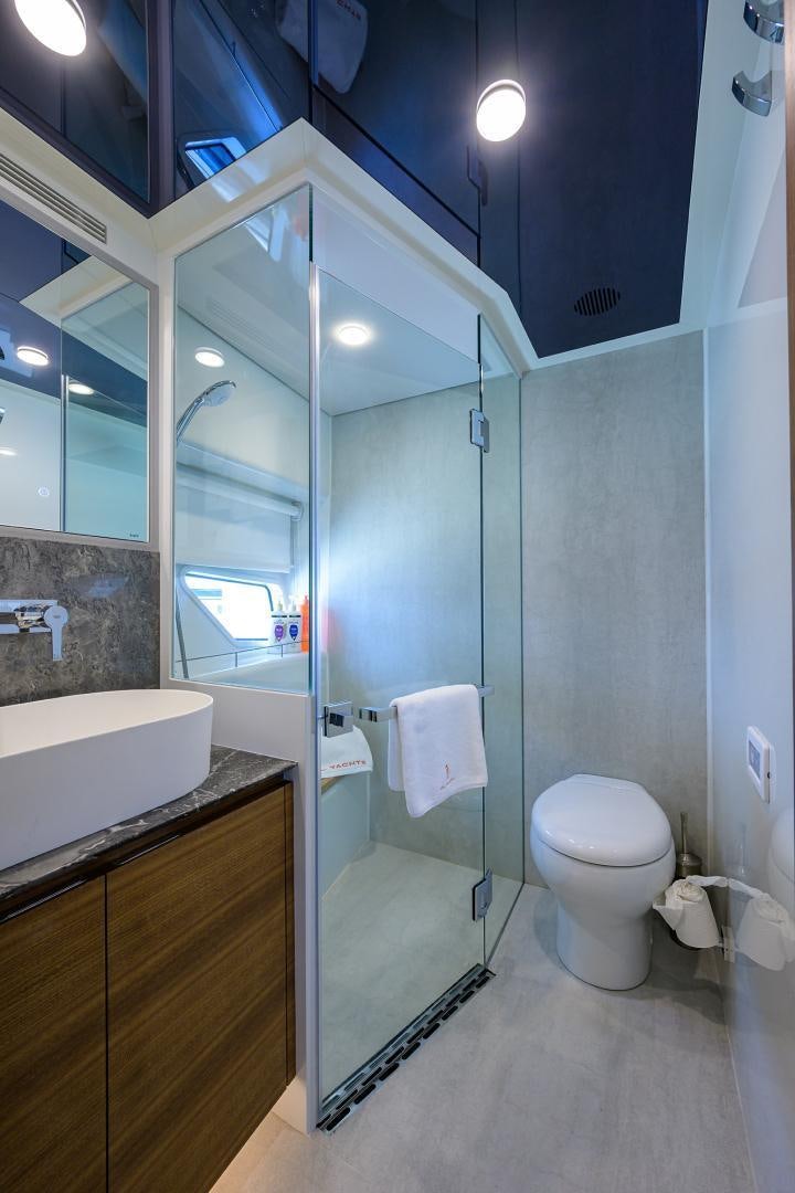 a bathroom with a glass shower aboard MY 3 GALS Yacht for Sale