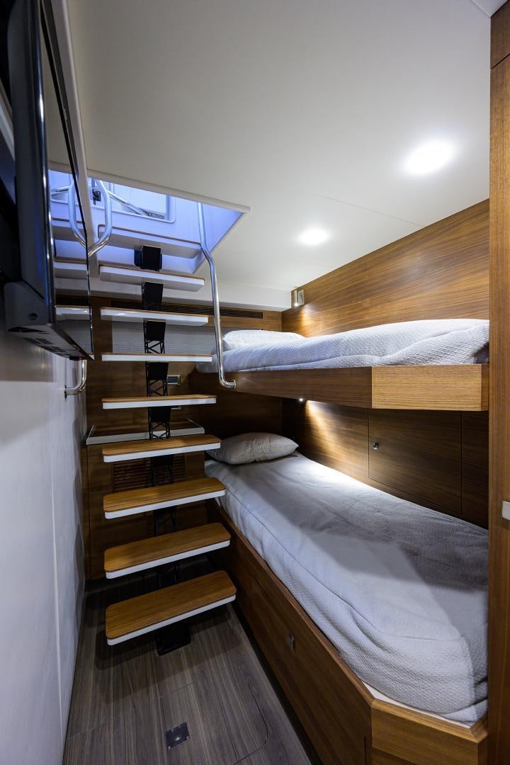a bunk bed with a wood headboard aboard MY 3 GALS Yacht for Sale