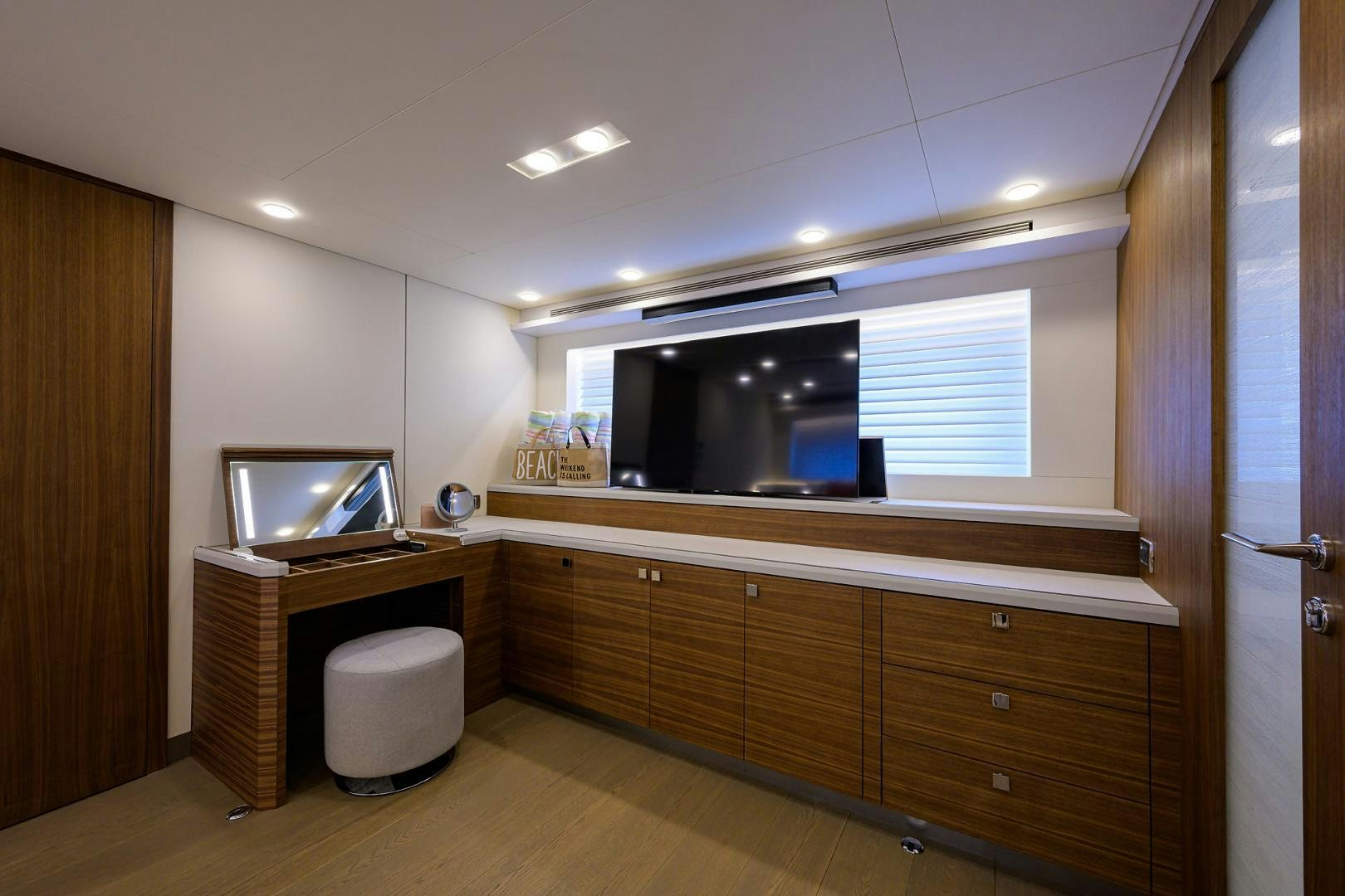 a room with a tv and cabinets aboard MY 3 GALS Yacht for Sale