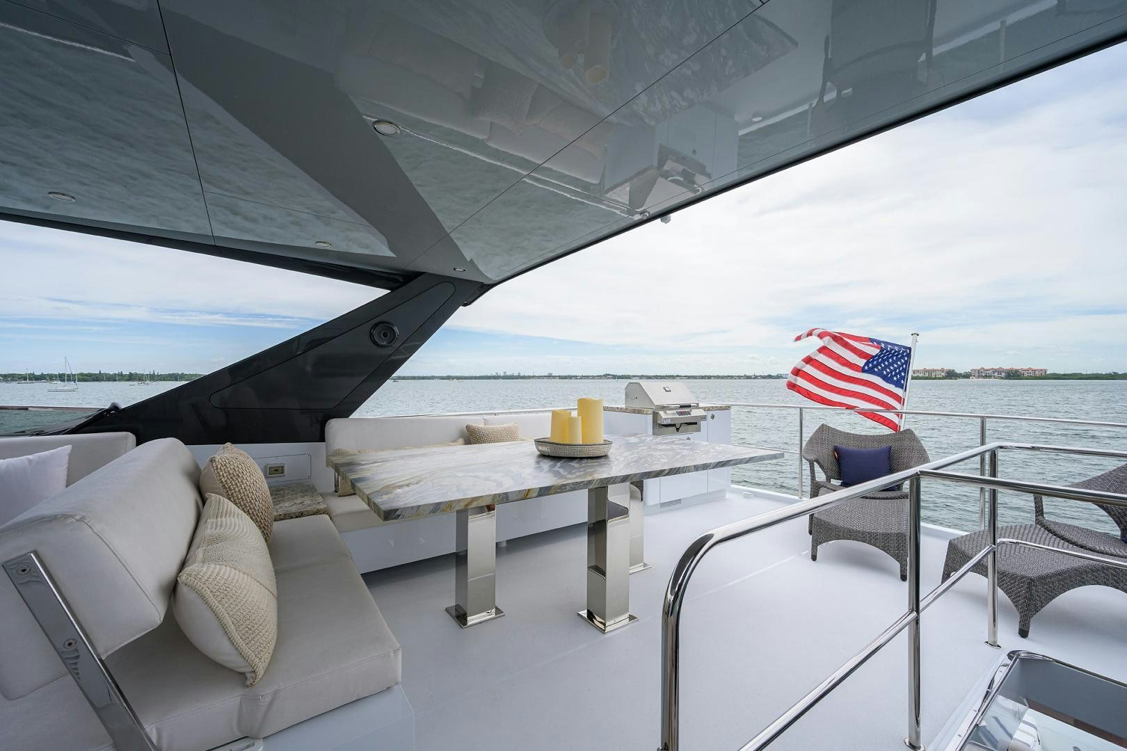 a boat with a table and a flag on it aboard MY 3 GALS Yacht for Sale