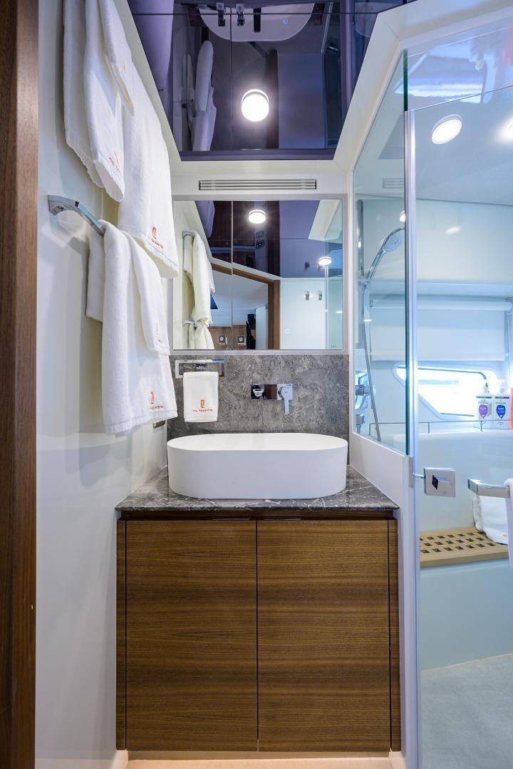 a bathroom with a sink and a mirror aboard MY 3 GALS Yacht for Sale