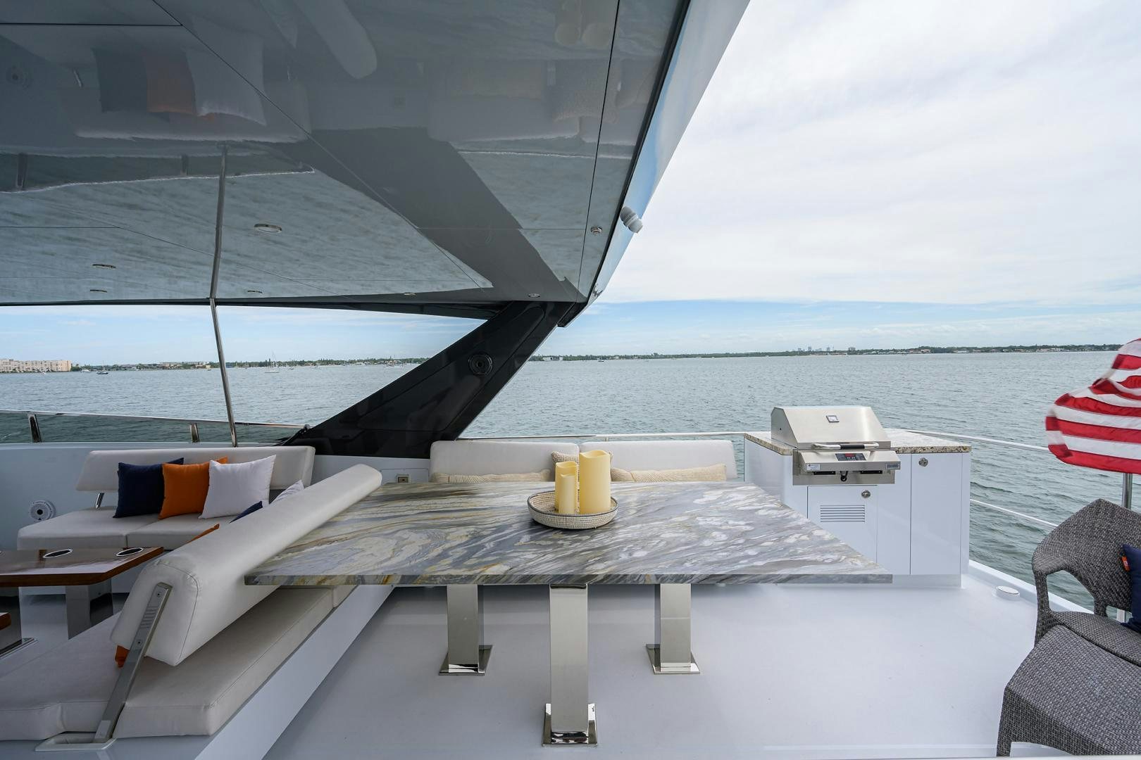 a table on a deck overlooking the ocean aboard MY 3 GALS Yacht for Sale