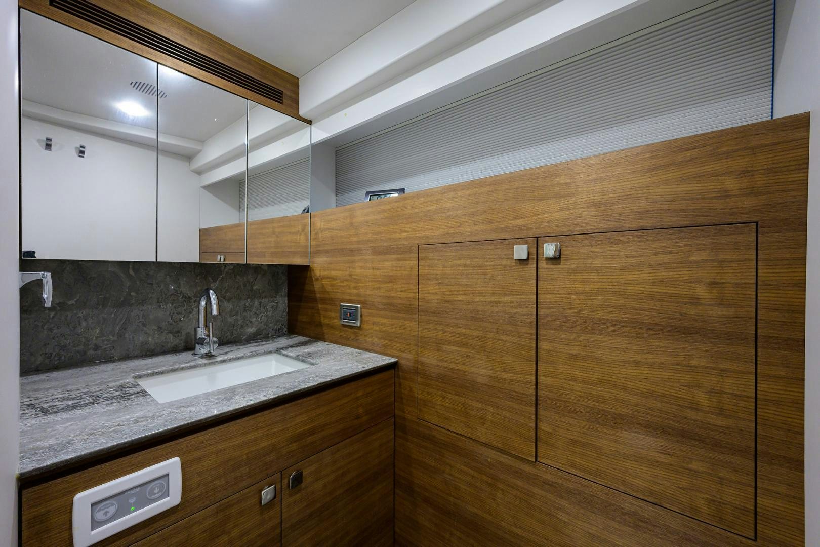 a kitchen with wooden cabinets aboard MY 3 GALS Yacht for Sale