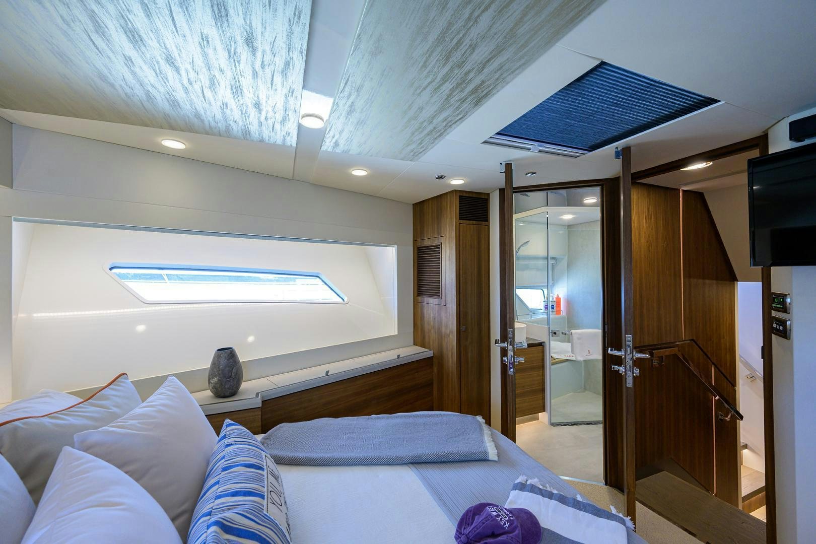 a bedroom with a bed and a television aboard MY 3 GALS Yacht for Sale