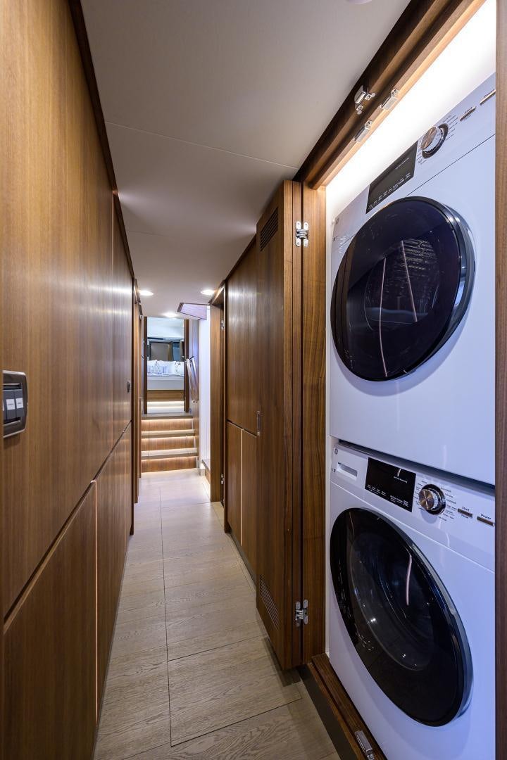a room with a washing machine and a door aboard MY 3 GALS Yacht for Sale