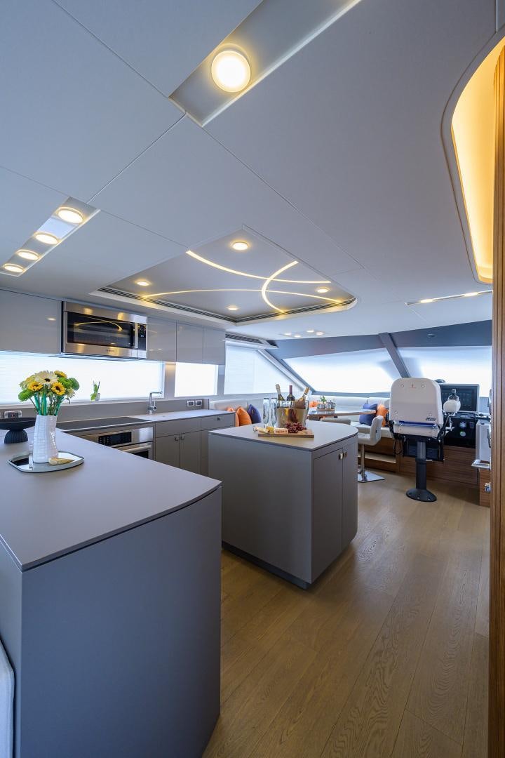 a large kitchen with white cabinets aboard MY 3 GALS Yacht for Sale