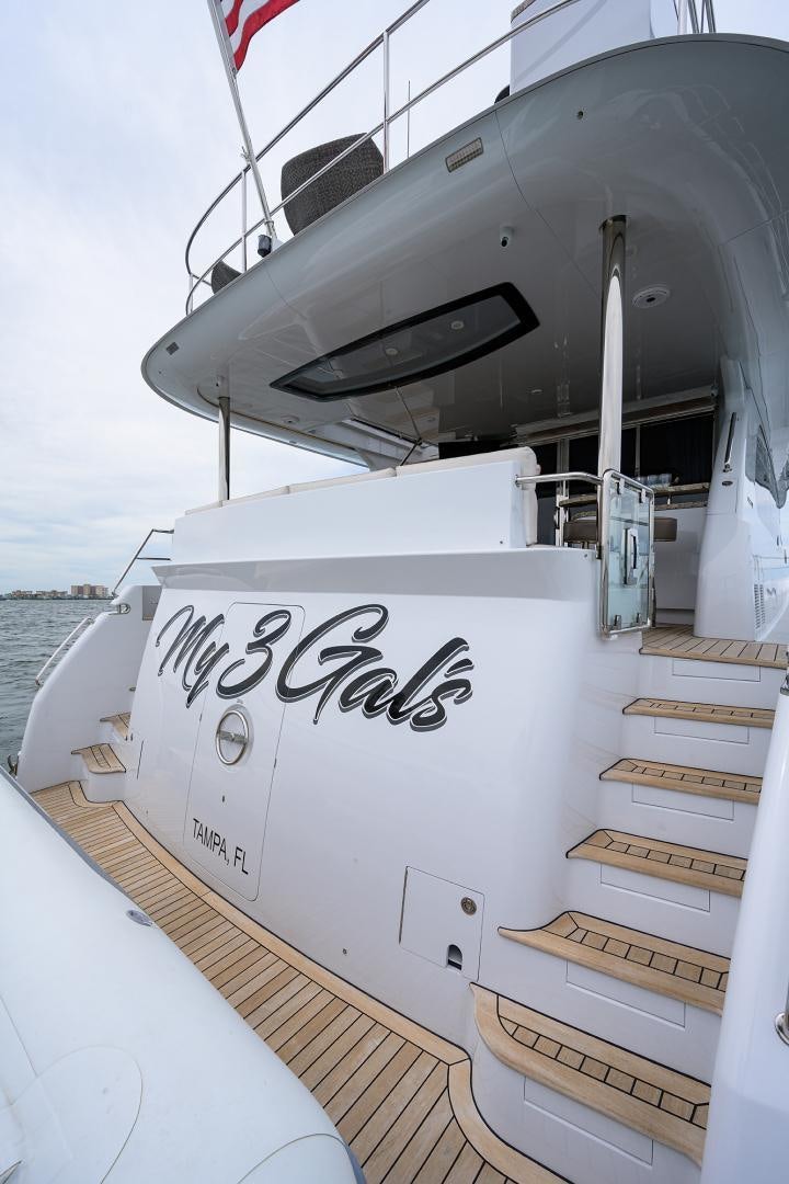 a boat with a sign on the front aboard MY 3 GALS Yacht for Sale