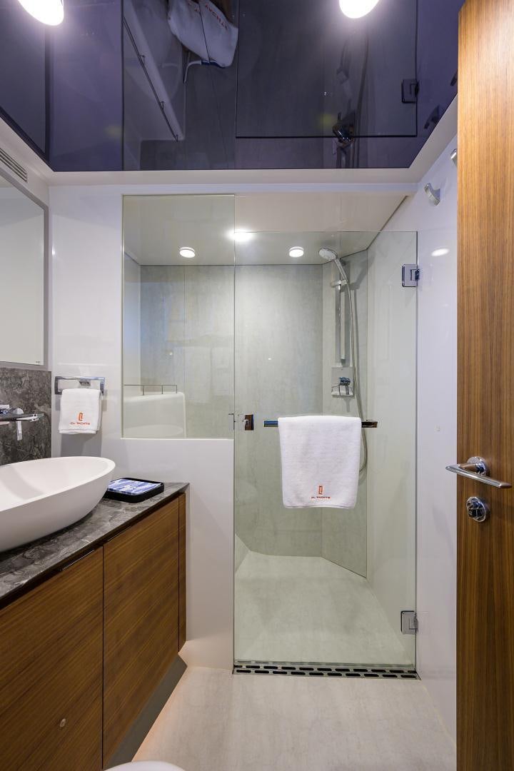 a bathroom with a glass shower aboard MY 3 GALS Yacht for Sale