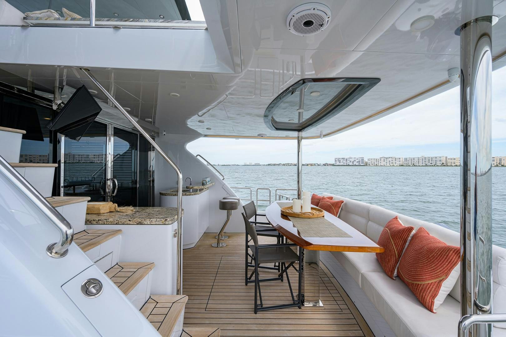 a boat with a table and chairs aboard MY 3 GALS Yacht for Sale