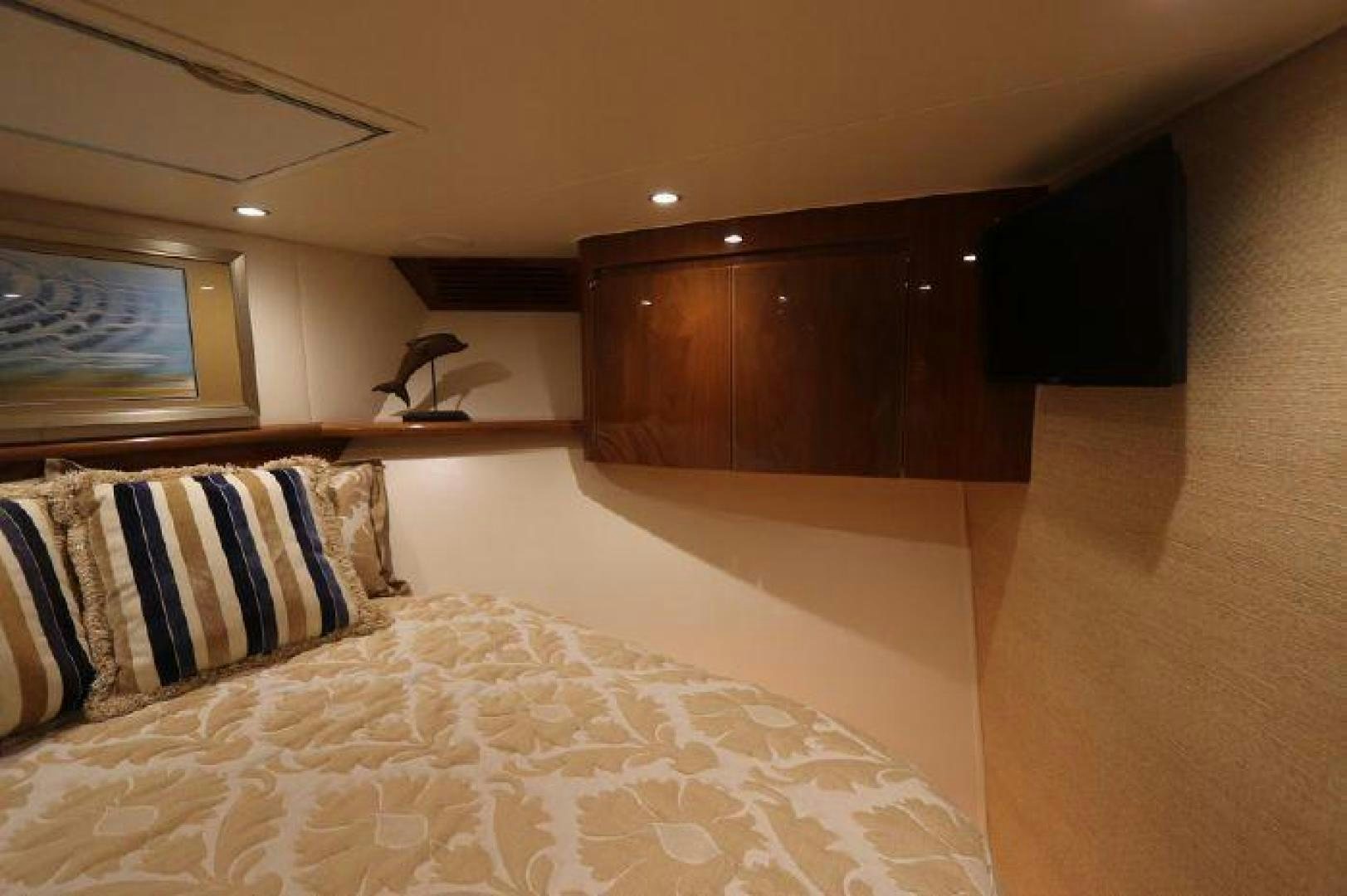 a bed with a white sheet and pillows aboard GABEA Yacht for Sale